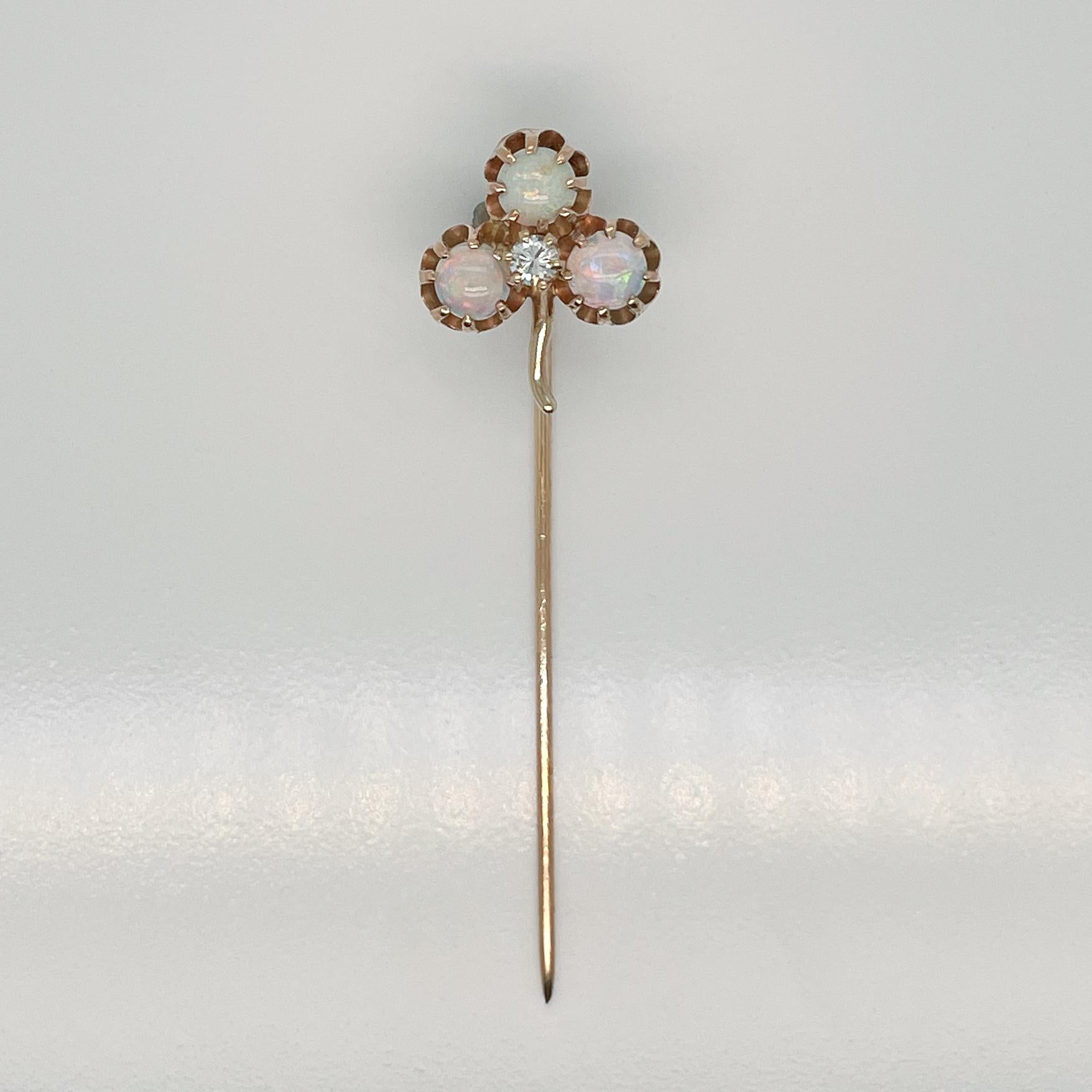 A very fine Edwardian 14k gold, opal and diamond stick pin.

With three opal cabochons prong set in 14k gold in a clover shape and a small round cut diamond is set at their center.

Simply a great stickpin!

Date:
19th Century

Overall Condition:
It
