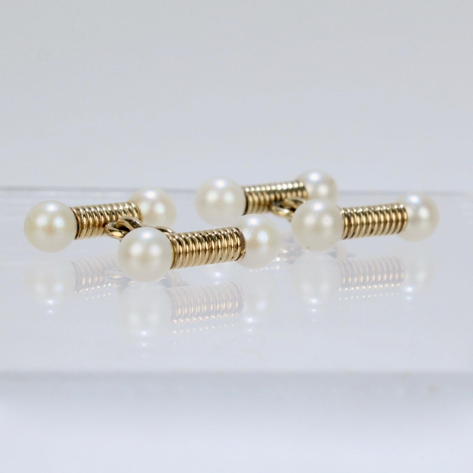 A fine pair of Edwardian gold & pearl cufflinks.

In 14k yellow gold. 

Each comprised of 2 spiral shaft heads terminating in round white pearls joined with a shaped link.

Simply top-shelf cufflinks!

Date:
20th Century

Overall Condition:
It is in