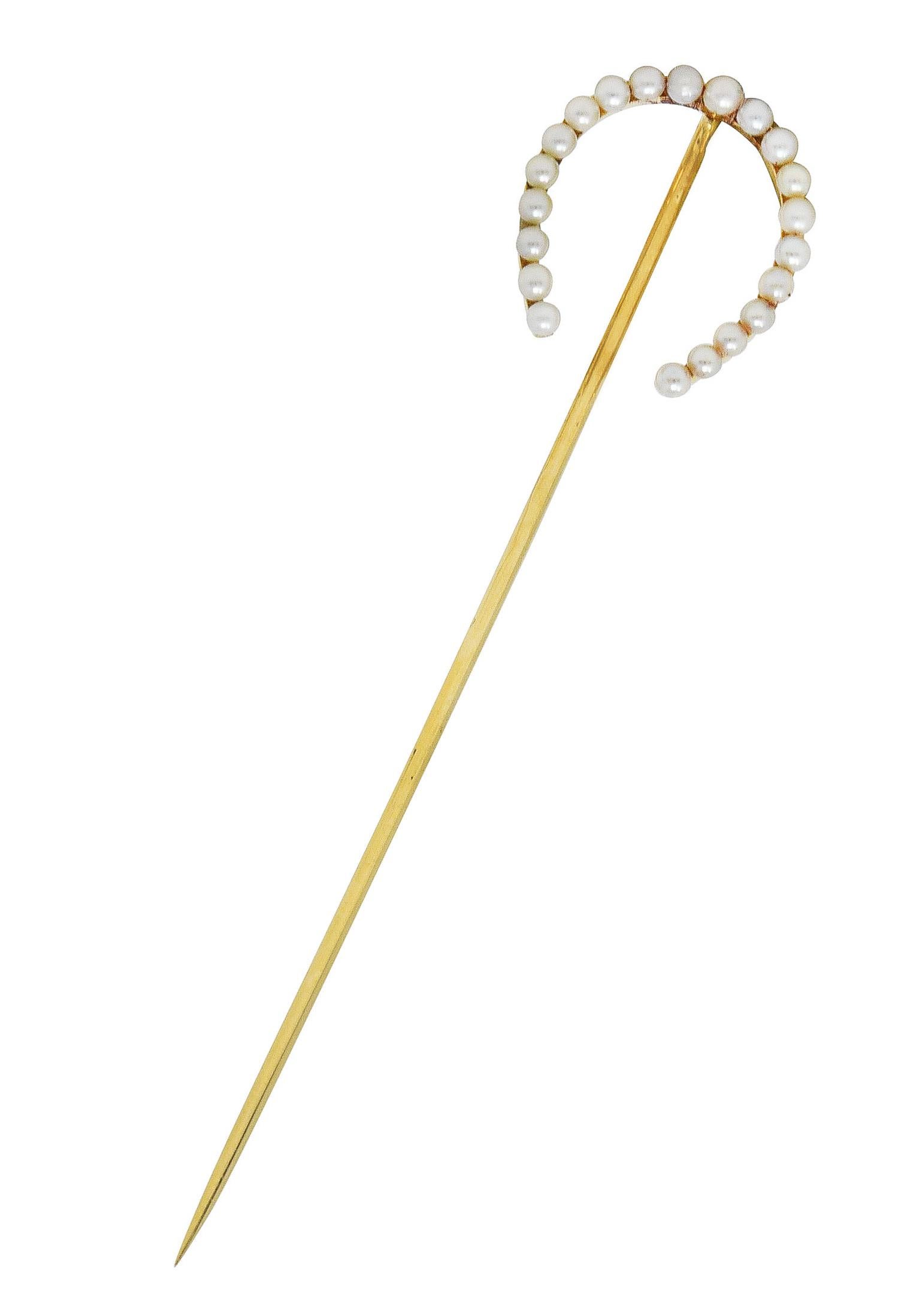 Stickpin is designed as a horseshoe form with seed pearls throughout. Ranging in size from 1.95 to 2.25 mm - white to cream in body color with subtle iridescence. Stamped 14k for 14 karat gold. Circa: 1910. Horseshoe measures: 5/8 x 3/4 inch. Total