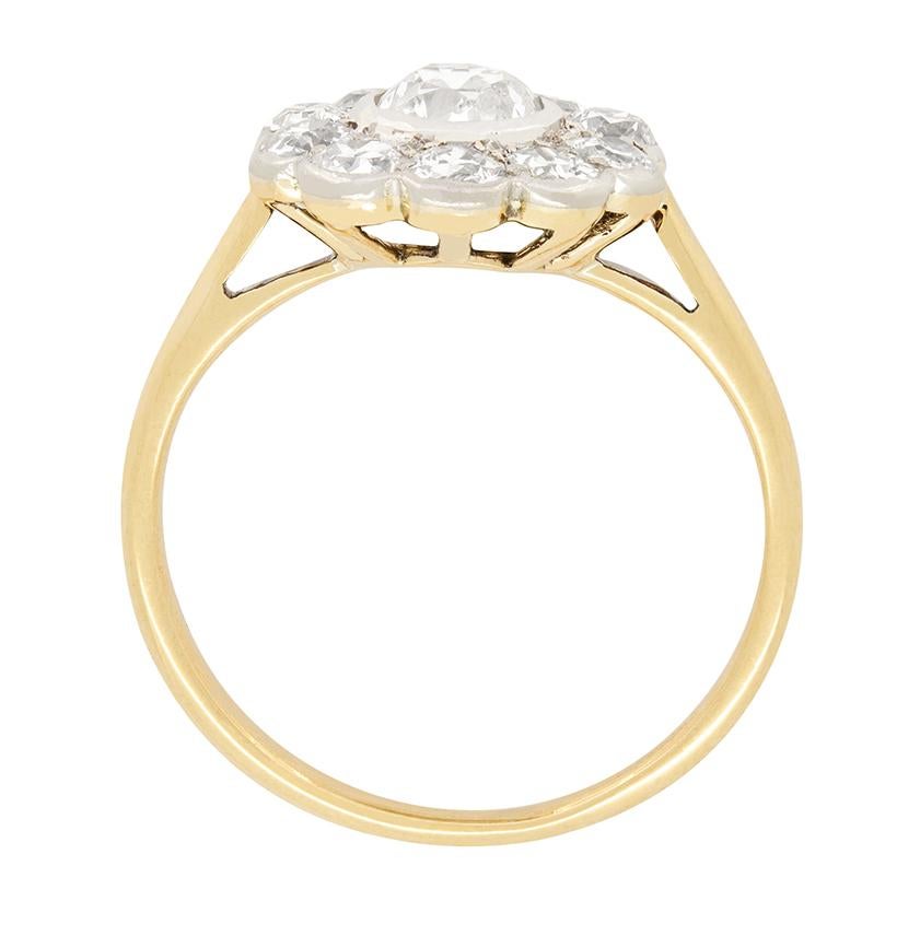 This wonderful Edwardian cluster ring centres around a rub over set old cut diamond.  The central stone weighs 0.40 carat, with the surrounding ten diamonds being 0.10 carat each and of the same cut. All the diamonds range in quality from H to I in