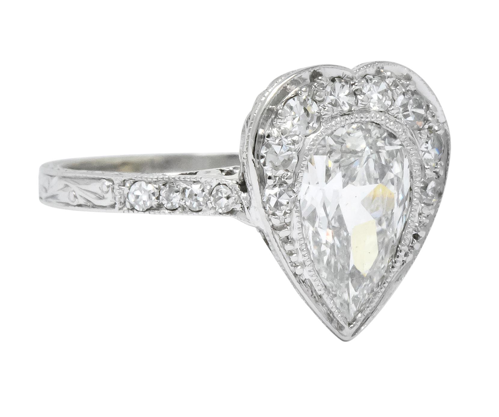 Centering a bezel set pear cut diamond weighing approximately 1.15 carats, I color and SI1 clarity

Accented with bead set single cut diamonds around and down the shank, weighing approximately 0.30 carat total, G/H color and VS to SI