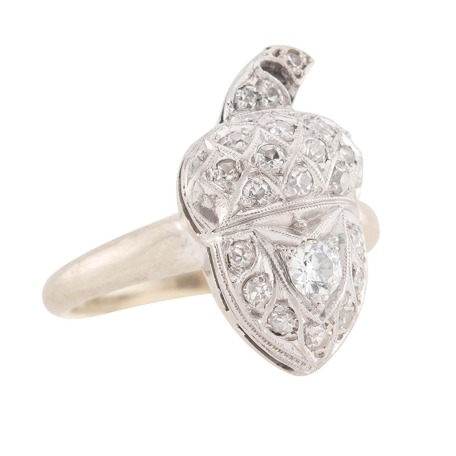 A one-of-a-kind diamond ring from the Edwardian (ca1910s) era! Crafted in 14k white gold, this ring features a centerpiece which resembles a dainty acorn. The entire surface of the acorn is encrusted with a variety of single cut and old European cut