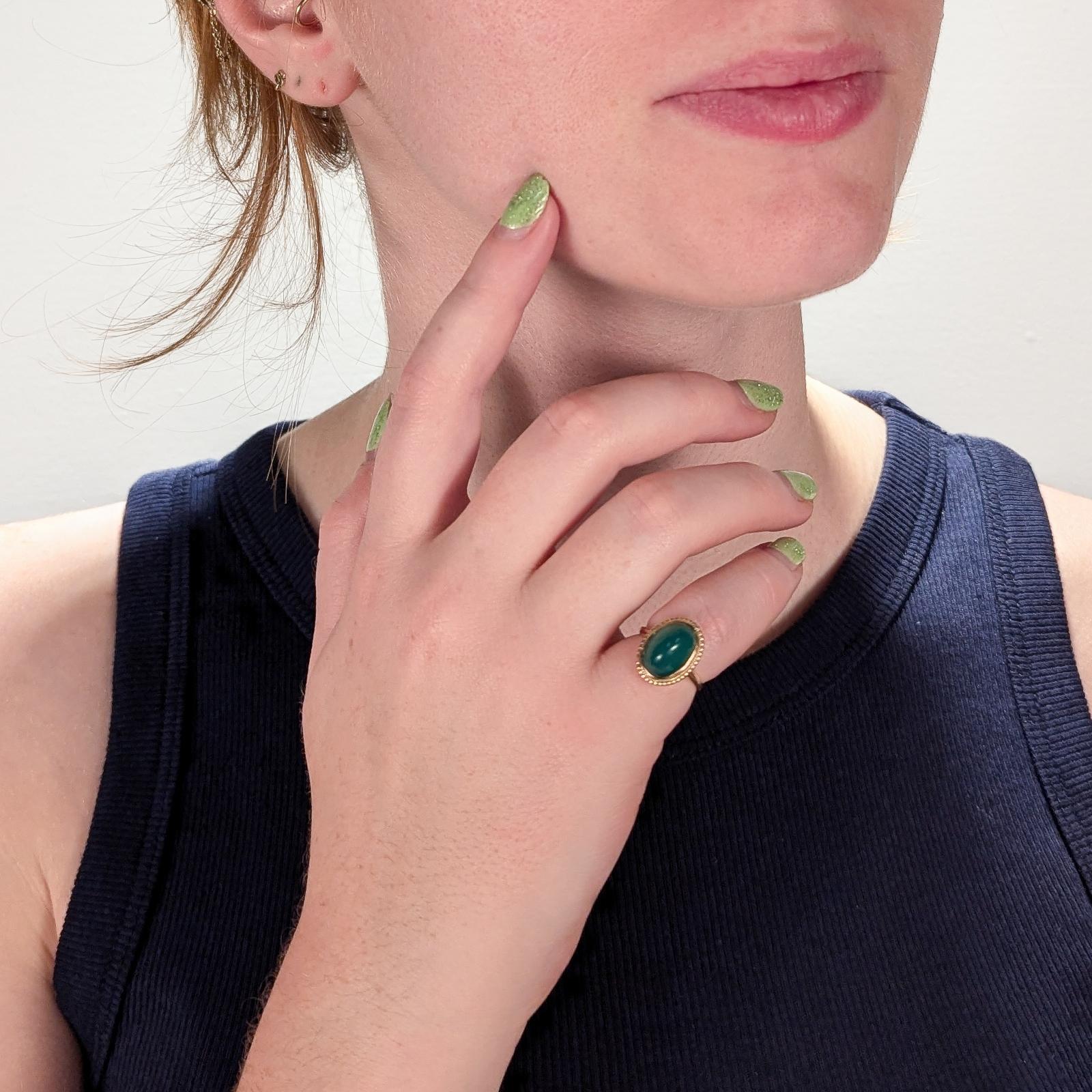 A fine antique Edwardian cabochon ring.

In 14 karat yellow gold.

Bezel-set with an oval chrysoprase sugarloaf cabochon in a beaded & twisted wire setting.

Marked 14k to the shank.

Simply a wonderful vintage ring!

Date:
Late 19th or Early 20th