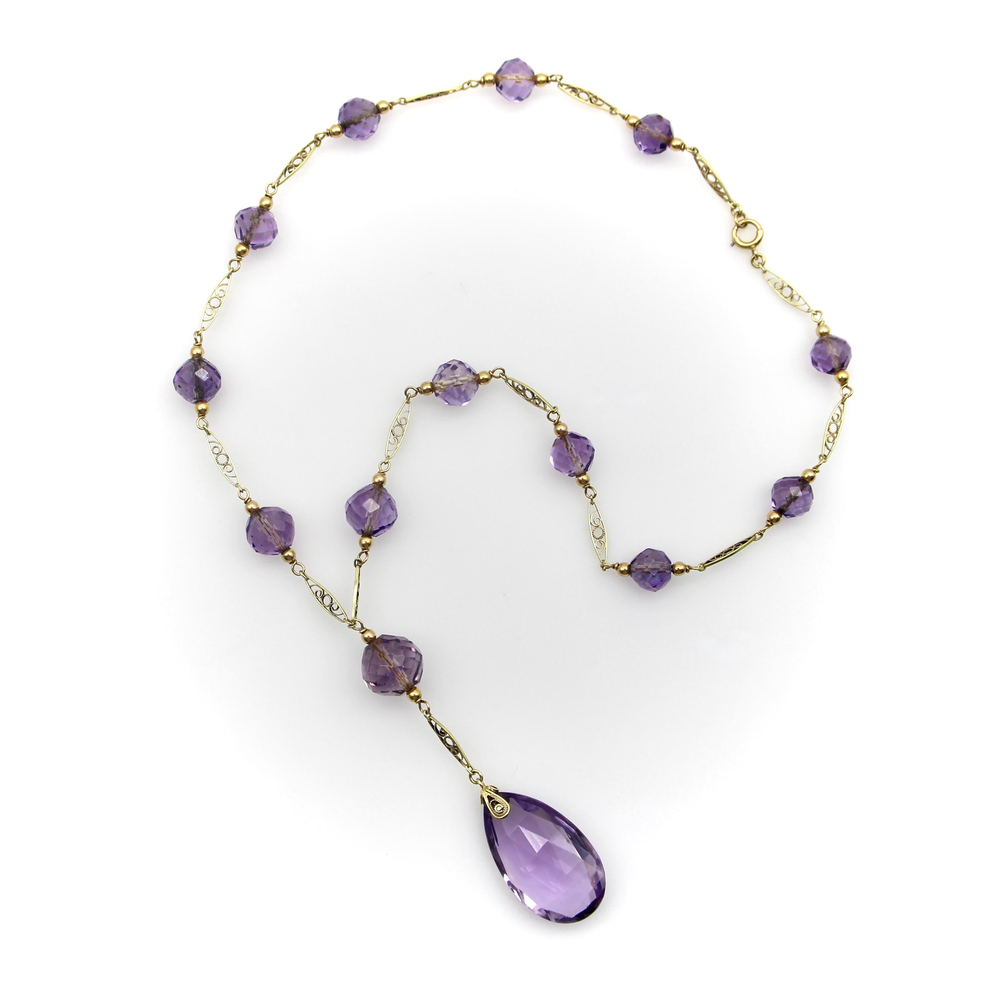The hand faceted Rose de France amethyst beads in this 14k gold Edwardian necklace have stunning facets that catch the light like prisms. The center stone is a flattened teardrop-shaped briolette with elongated triangular facets. The round beads