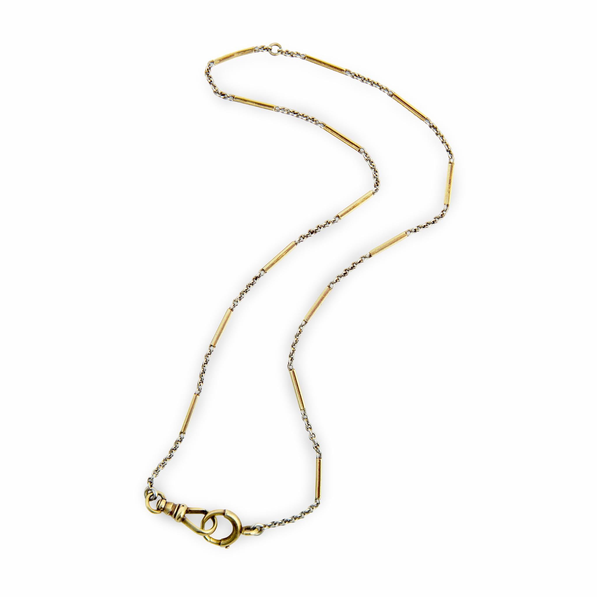 A stunning watch chain necklace from the Edwardian (ca1910s) era! Crafted in 14k yellow and white gold, this necklace is comprised of 14 ribbed rectangular links, which are yellow gold-toned. The rectangular links alternate with white gold