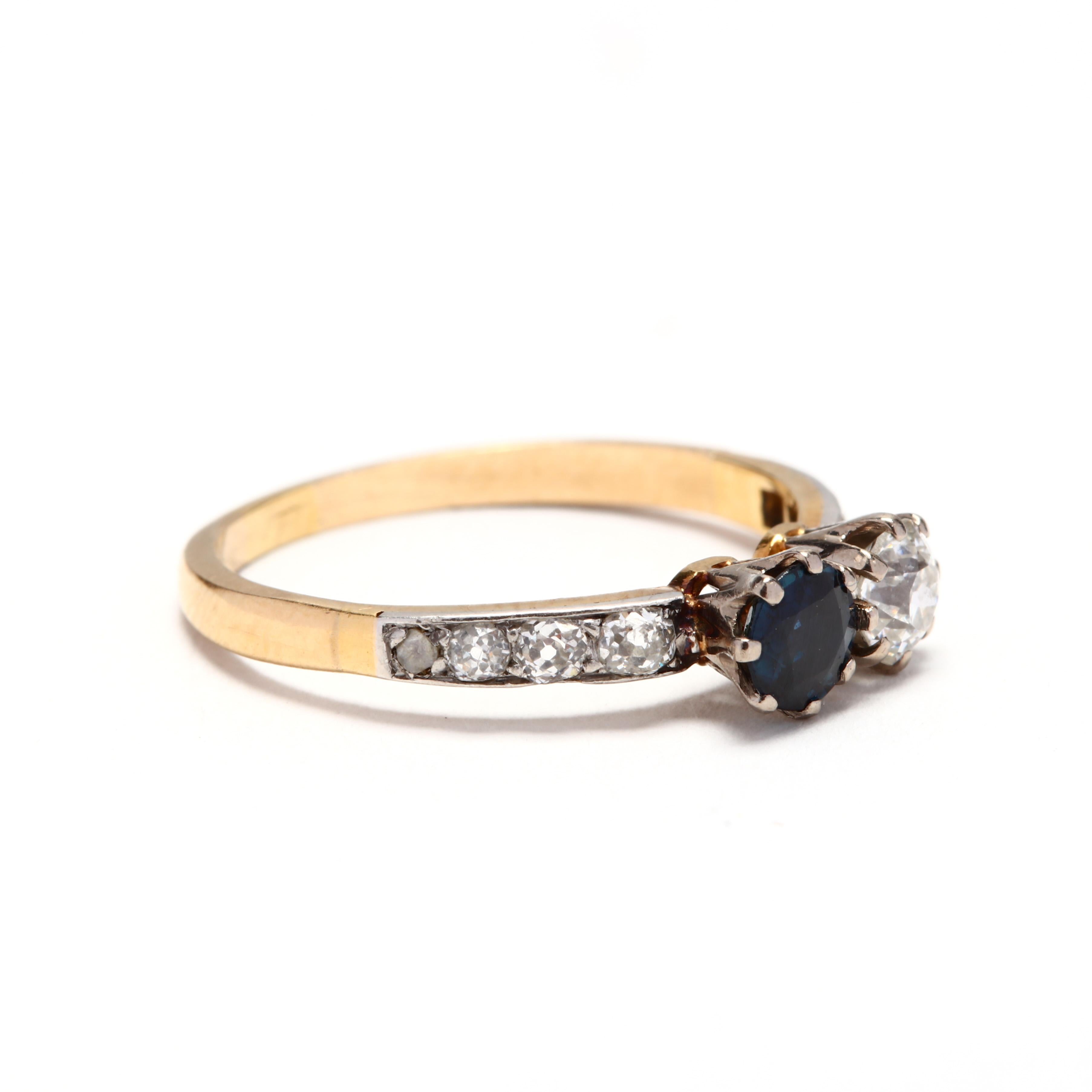 An Edwardian 14 karat yellow and white gold diamond and sapphire Toi et Moi ring. This ring features a prong set round cut sapphire and old European cut diamond set side by side and with old rose cut diamonds on the shank.

Stones:
- diamonds, 9