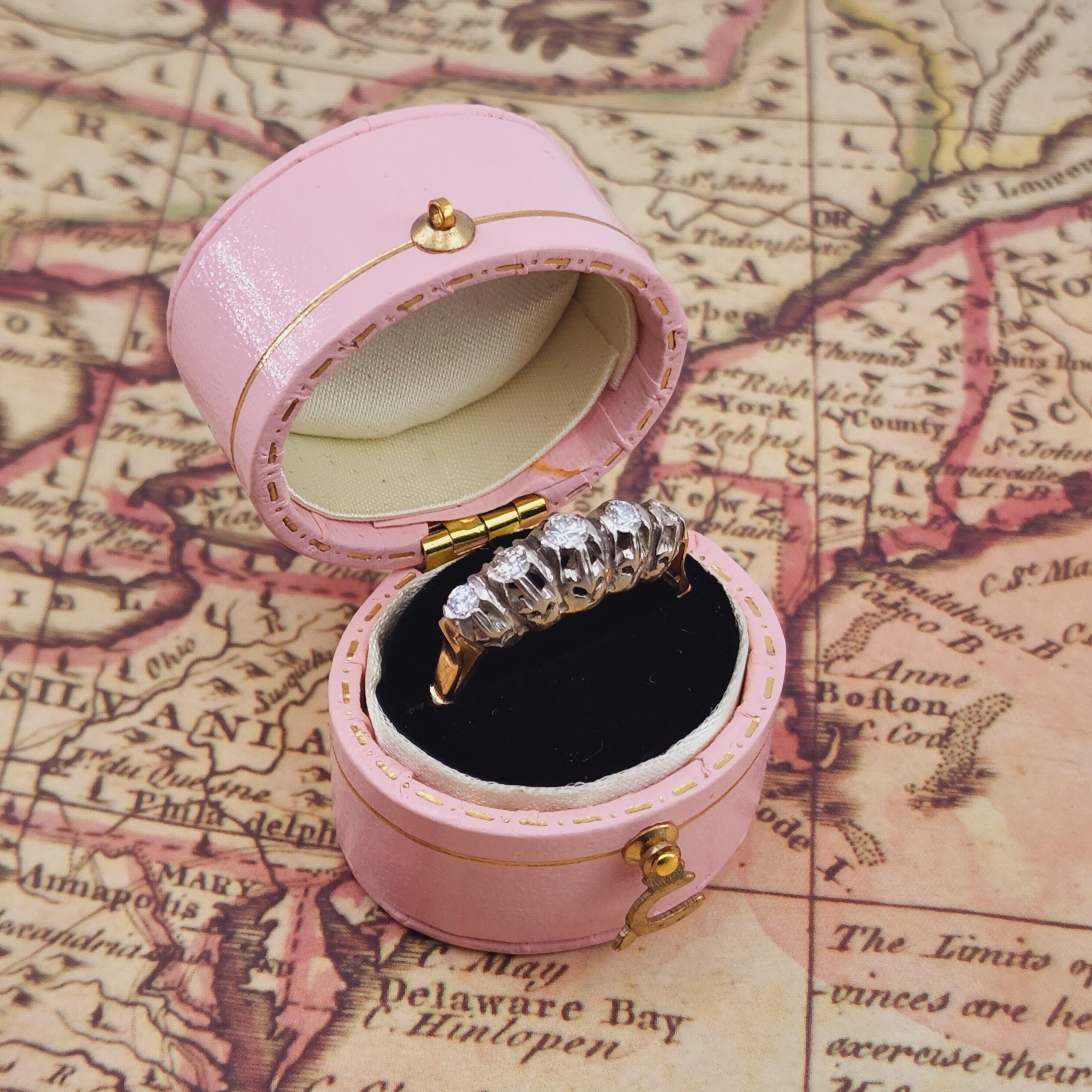 This exquisite Edwardian-era ring, originating from the 1910s, is a stunning testament to the elegance and sophistication of its time. Crafted in a luxurious combination of 14kt yellow gold and platinum, this ring reflects the artistry and