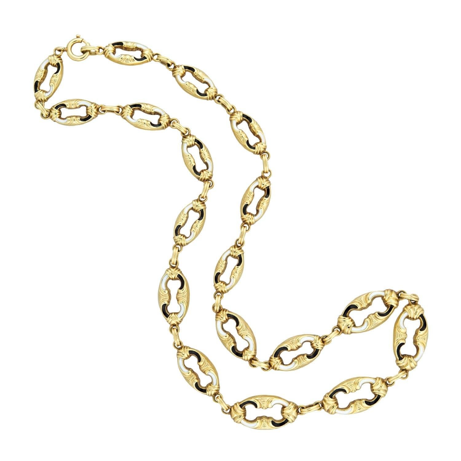 A wonderful Swiss enamel chain from the Edwardian (ca 1900s)era! Crafted in bright 14kt yellow gold, the piece is comprised of open oval links that graduate in size and connect to form a gorgeous flexible chain. An incredible black and white Swiss