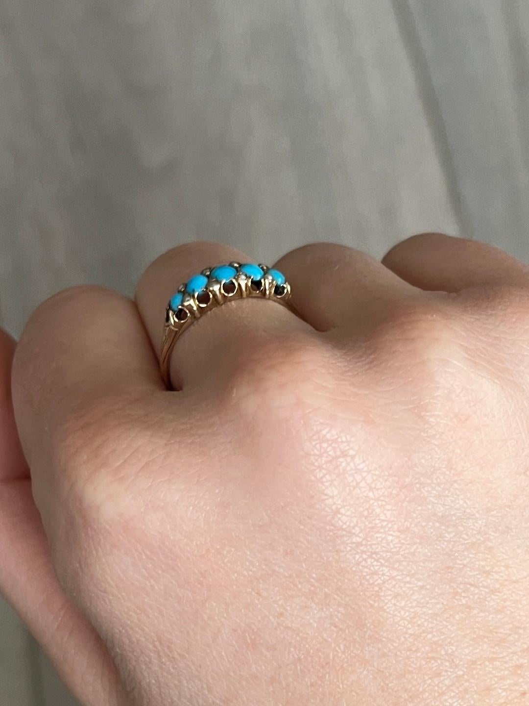 A spectacular five-stone ring. Set with five wonderful cabochon cut turquoise with pearl points in between. Modelled in 15 carat yellow gold.

Ring Size: P 1/2 or 8 
Band Width: 5.5mm
Height Off Finger: 4mm

Weight: 1.9g