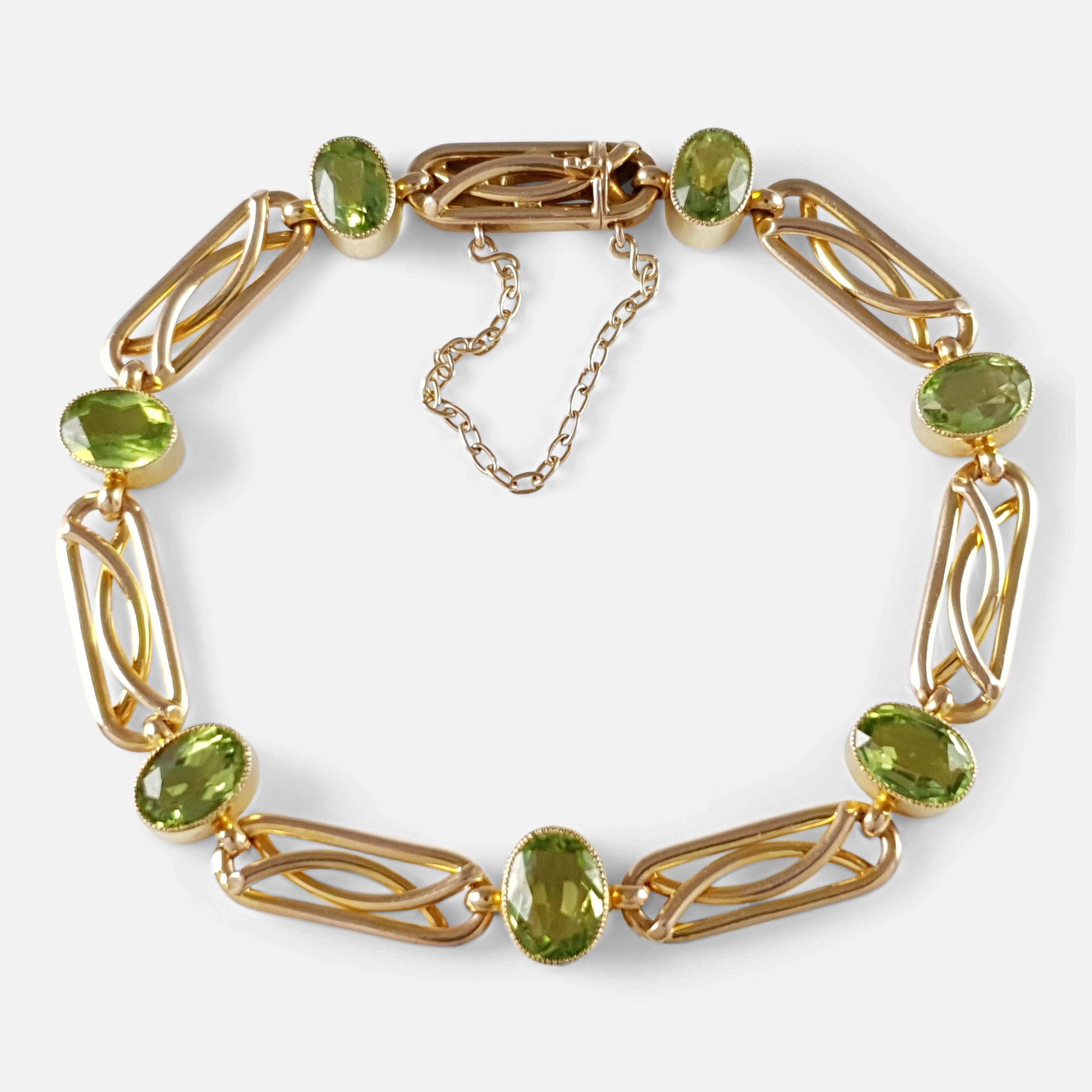 Description: - This is a stunning antique Edwardian 15 karat yellow gold peridot link bracelet circa 1905. The clasp is stamped '15ct' to denote 15 karat (carat) gold.

Measurement: - The bracelet has a internal circumference of  approximately 19cm
