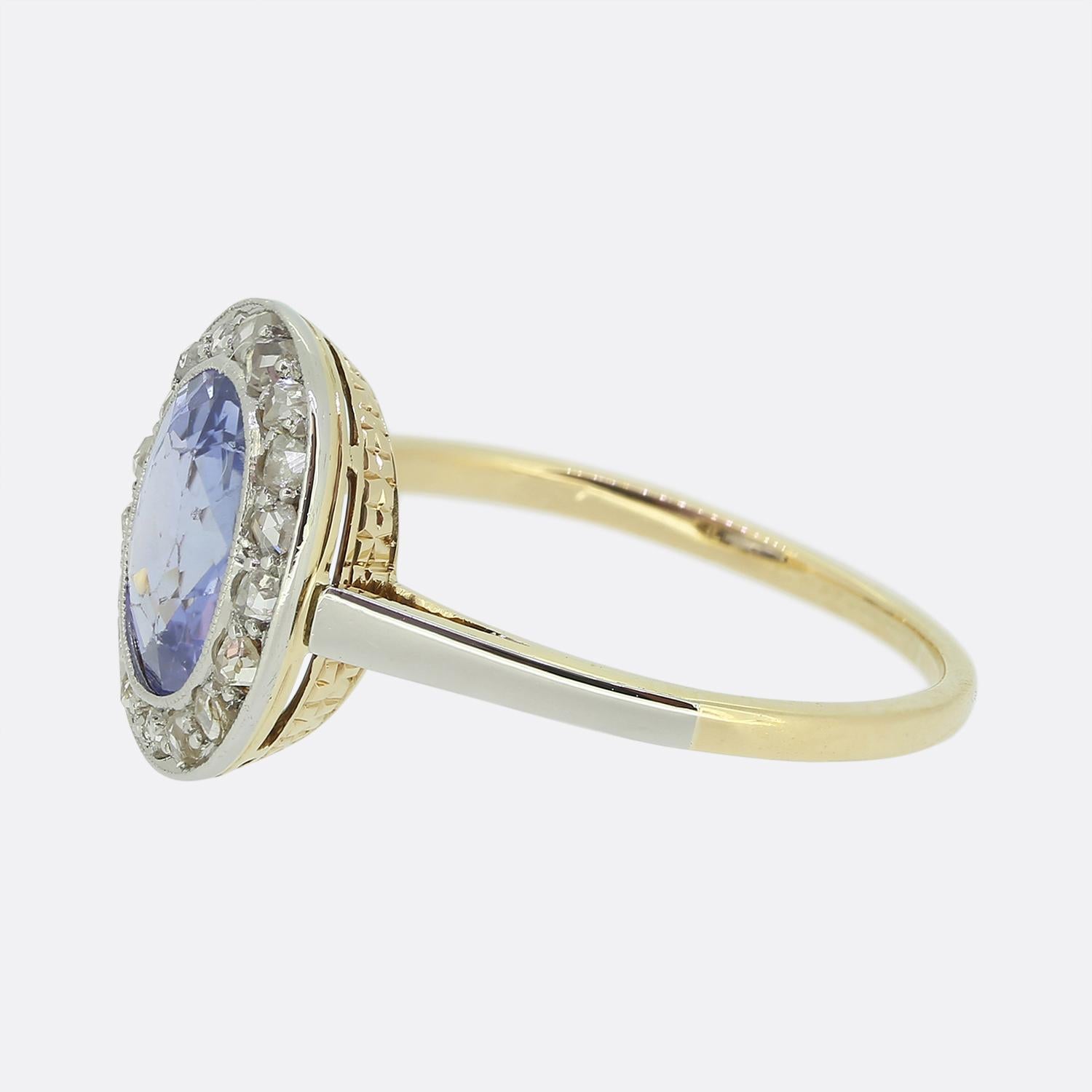 Here we have a beautiful sapphire and diamond halo ring taken from the Edwardian period. At the centre we find a captivating 1.50ct oval faceted sapphire possessing a medium light blue colour tone. This radiant principal stone is then surrounded by