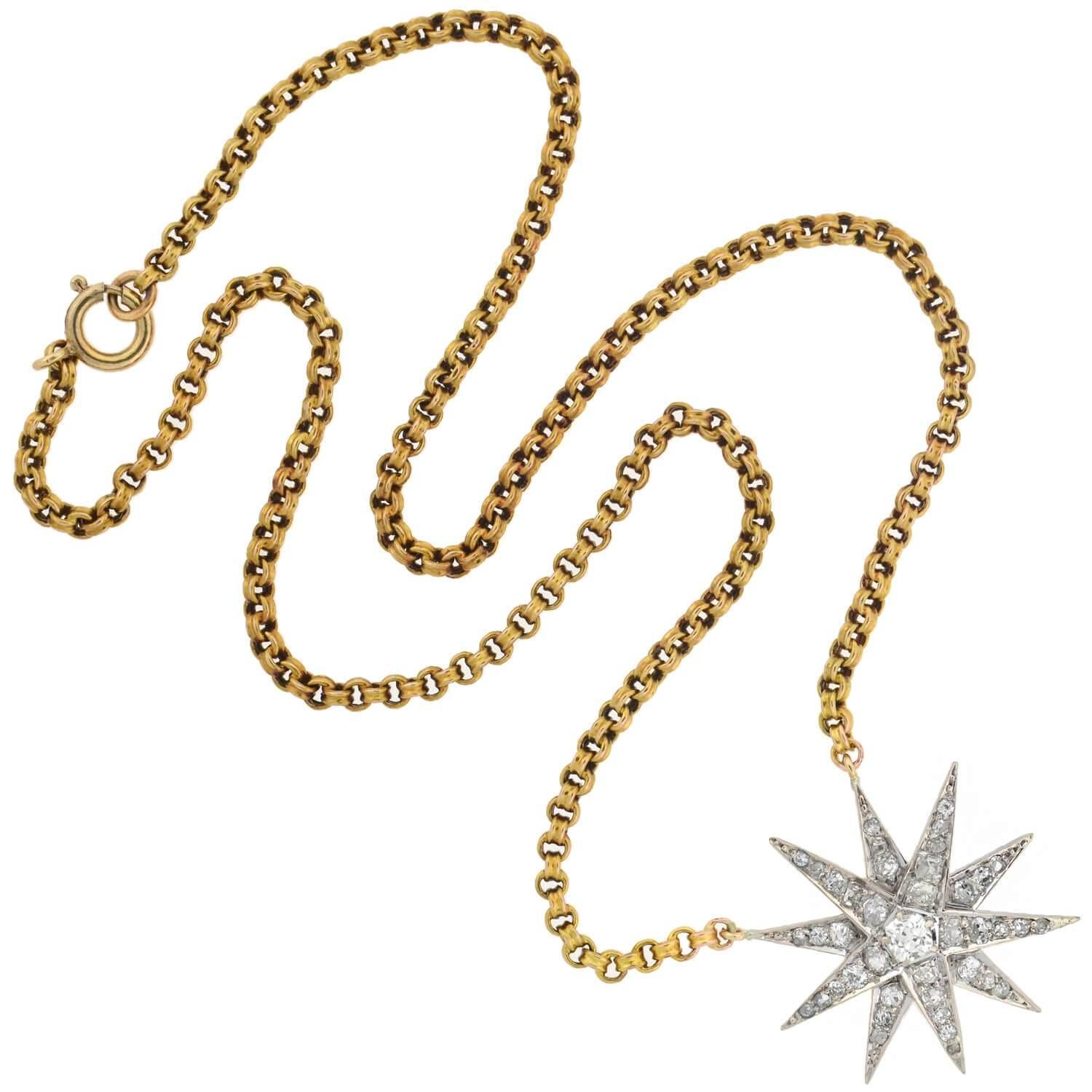 A breathtaking diamond starburst pendant necklace from the Edwardian (ca1910) era! This gorgeous piece is crafted in 14kt white and yellow gold and comprised of a dazzling starburst which hangs at the center of a lovely Victorian-era chain. The 10