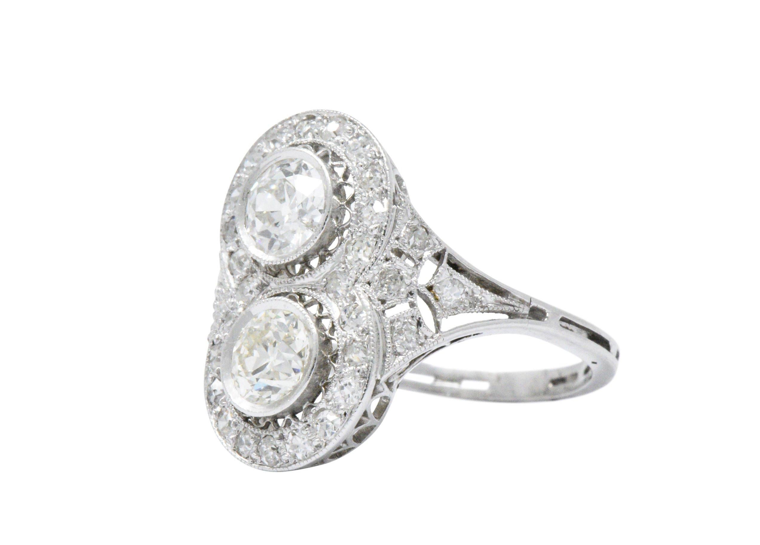 Platinum Edwardian Toi et Moi (French for you and me) ring 

Centering 2 old European cut diamonds, H/J Color, VS to SI clarity, approximately 1.00 CTW

Accented by clean old mine and single cut diamonds weighing 0.54 CTW  

Top measures 18.40 mm
