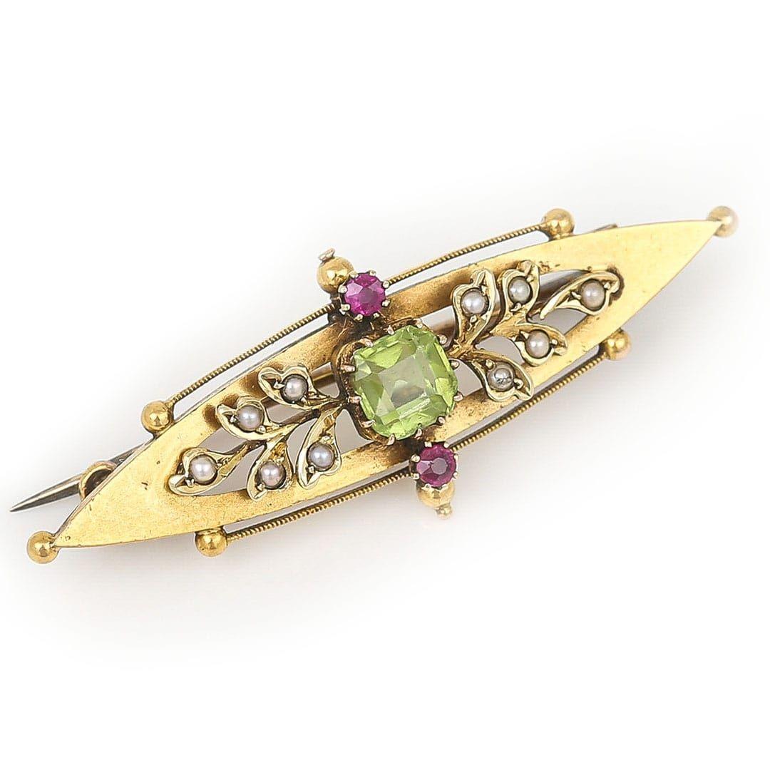 A pretty and symbolic brooch this piece can be dated back to the early 20th century and its colours (green, red, white) used to represent the Suffragette movement. Made of buttery 15ct gold, the ellipse shaped body is centrally set with square cut