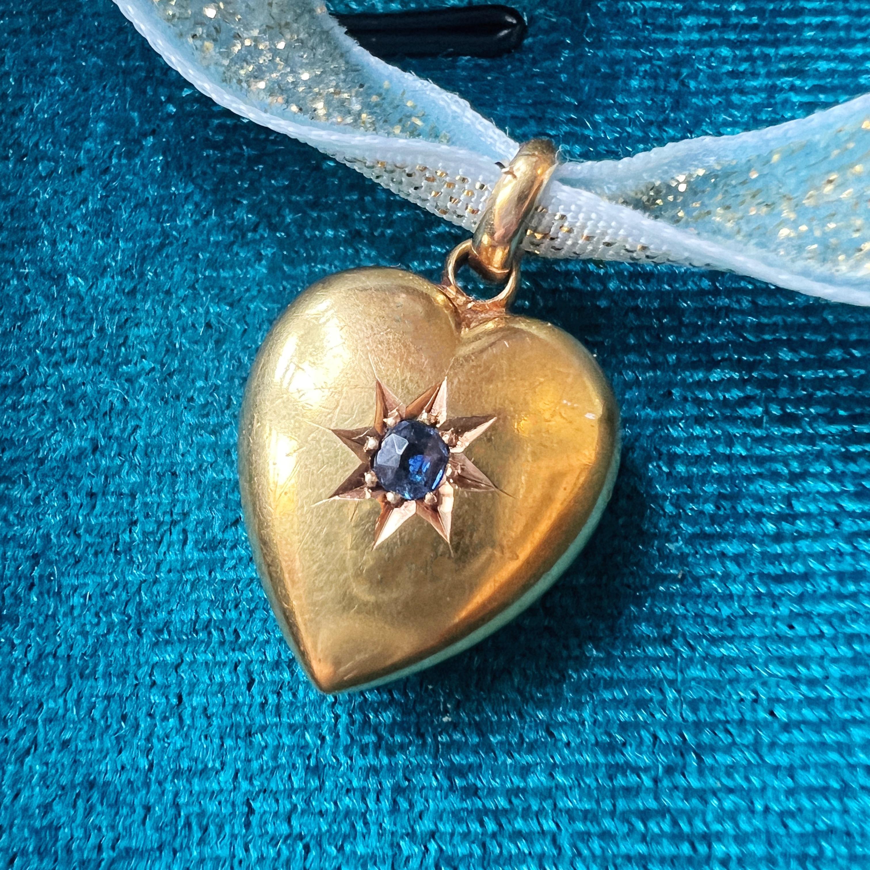 For sale a very sweet 15K gold puffy heart pendant from the Edwardian era.

At the heart of this pendant lies a lustrous blue sapphire star, casting a celestial glow within the warm embrace of buttery 15K gold.

The heart, a perennial symbol of