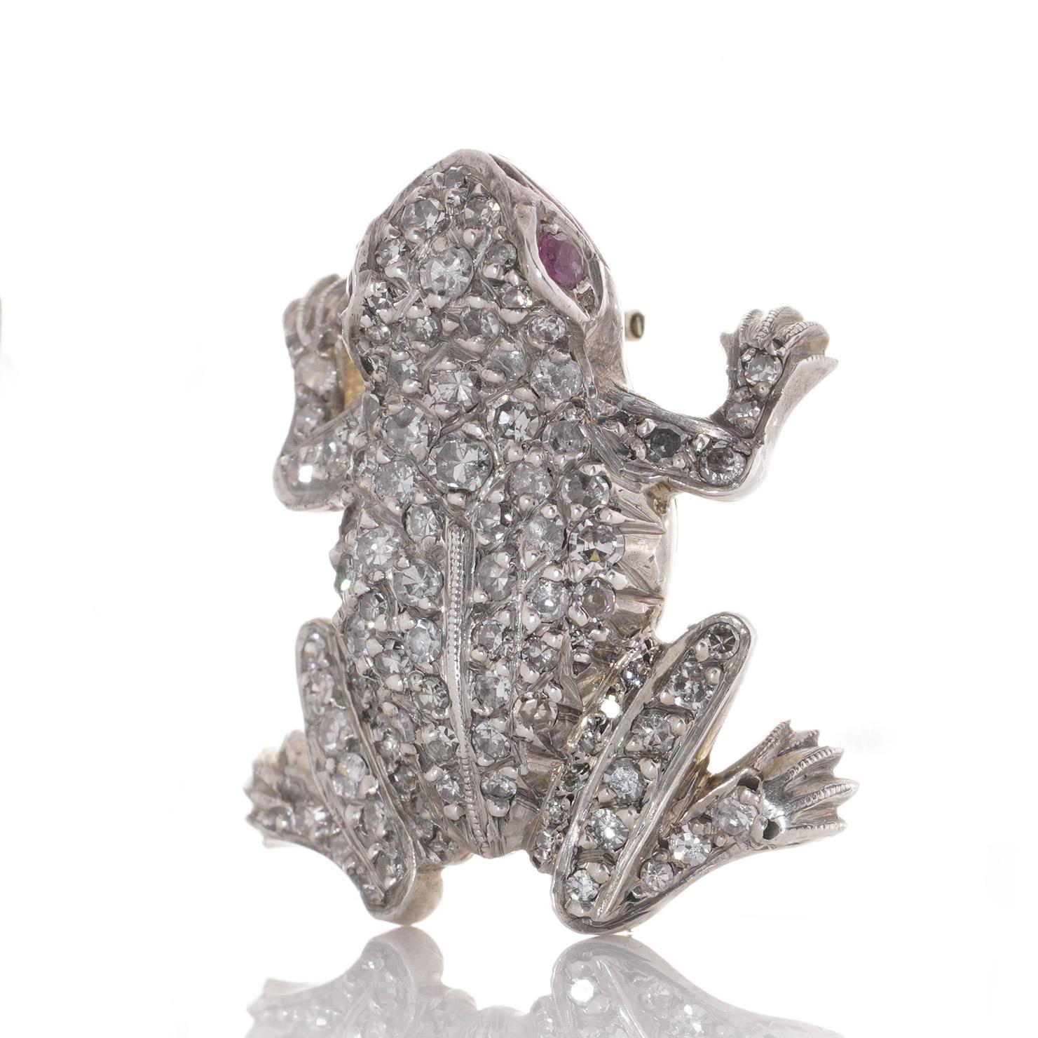An enchanting lapel brooch from the Edwardian era, crafted in 15kt yellow gold and silver and set with diamonds and rubies takes the form of a charming frog.

The brooch showcases intricate detailing and skilled craftsmanship. The frog's body is
