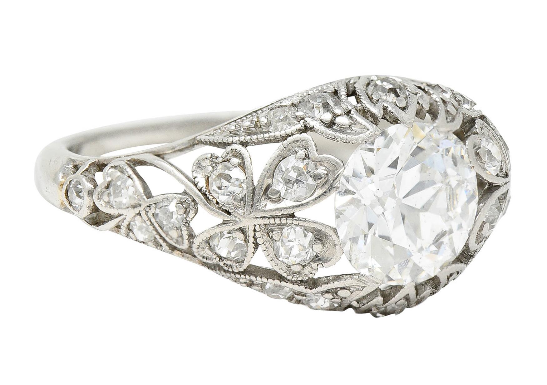 Bombè style band is pierced - featuring lily of the valley and clover motifs

Centering a transitional cut diamond weighing approximately 1.05 carats - H color with SI2 clarity

Accented throughout by old European cut diamonds weighing in total