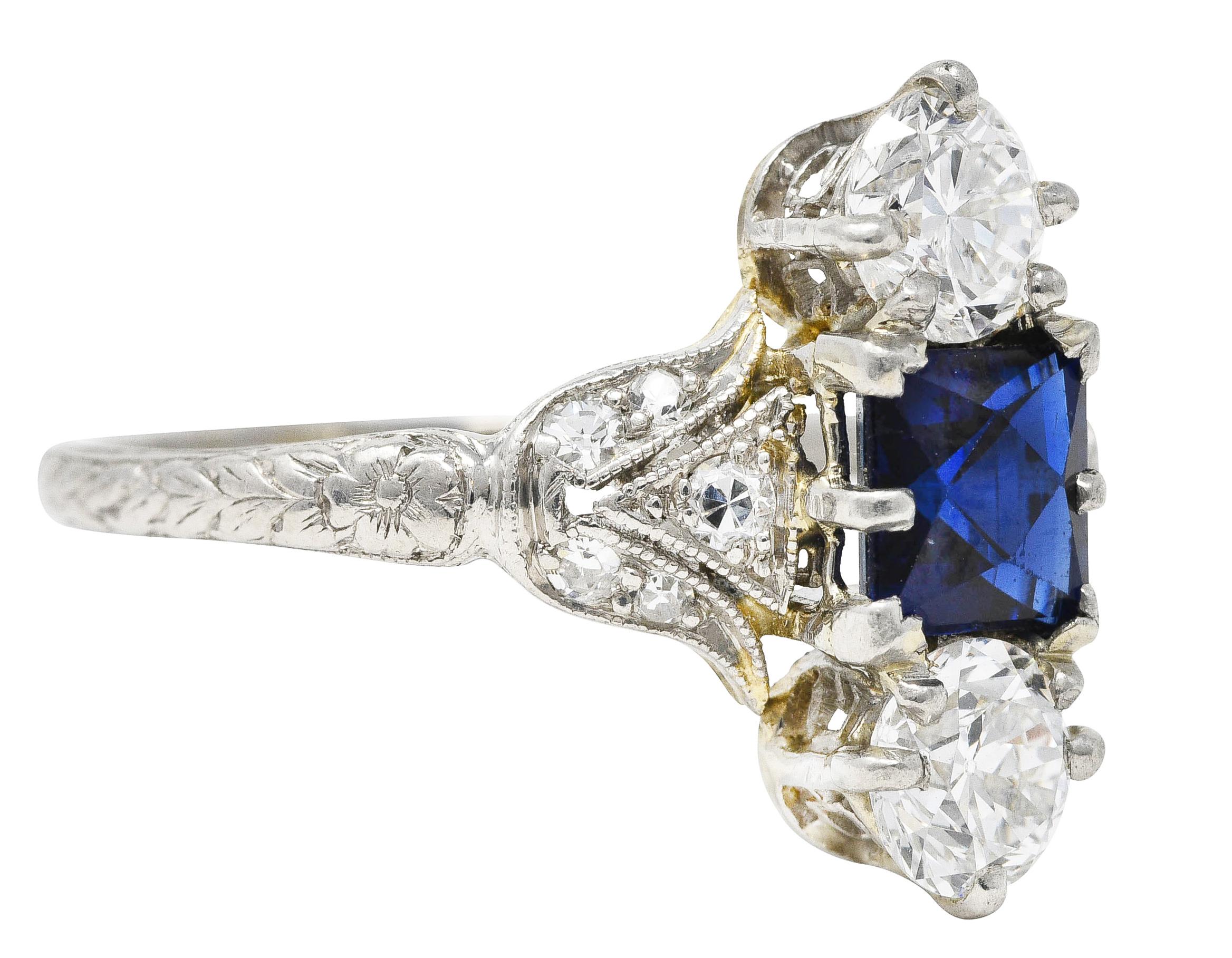 Antique ring features three basket set gemstones set North to South. Centering a French cut sapphire weighing approximately 0.85 carat - medium dark blue. Flanked by a transitional and an old European cut diamond. Weighing 0.70 carat total with well