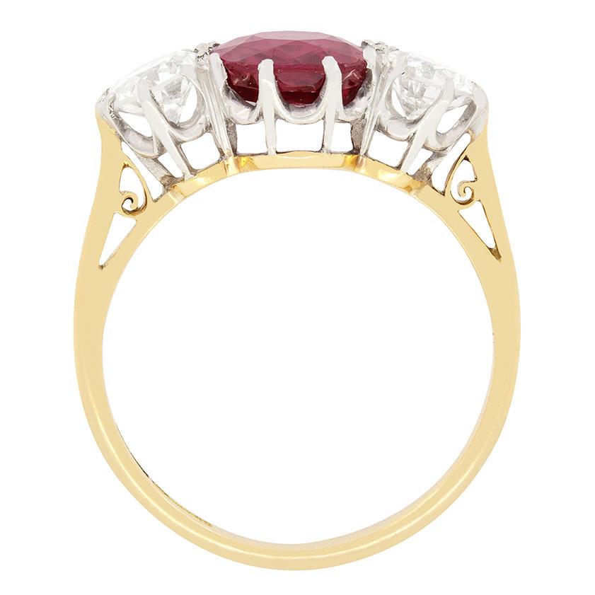 A natural, unheated ruby takes centre stage flanked by a pair of old cut diamonds in this gorgeous Edwardian trilogy ring. The vibrant ruby is an old cushion cut stone and weighs 1.70 carat. The old cut diamonds weigh 0.40 carat a piece and match in