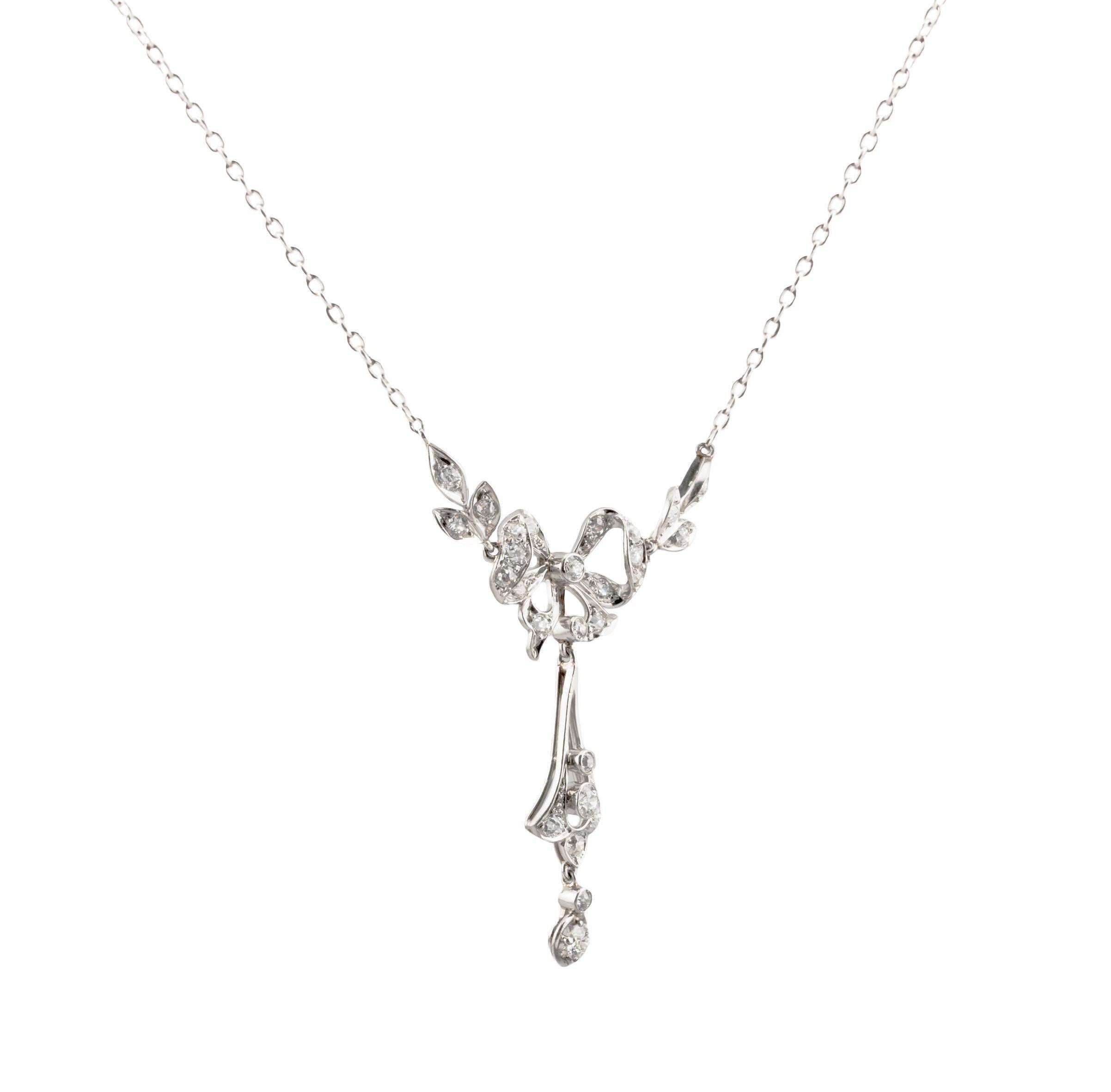 Aston Estate Jewelry Presents:

A unique Edwardian period diamond lavalier necklace in platinum. Centered by a diamond set platinum bow framed with diamond leaves.  Completed by a tapered diamond set pendant and a double diamond drop.  Weighing a