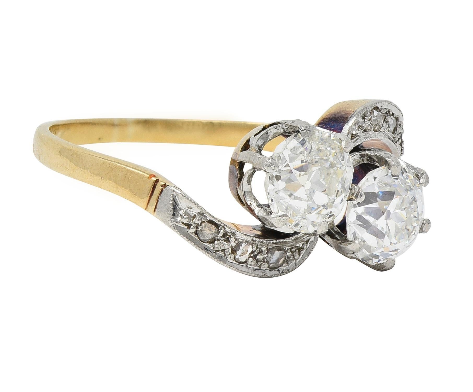 Designed as a Toi et Moi style bypass ring terminating with two old mine cut diamonds prong set in platinum 
Weighing approximately 1.68 carats total - H/I color with VS2 clarity
Flanked by swirled rows of rose cut diamonds 
Weighing approximately