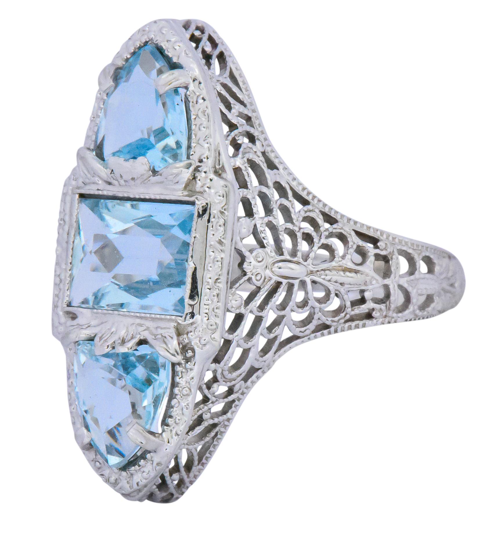 Centering a rectangular scissor cut aquamarine weighing approximately 0.75 carat

With two rounded triangular scissor cut aquamarines above and below, weighing approximately 1.00 carat

All aquamarines are very slightly greenish blue

Detailed