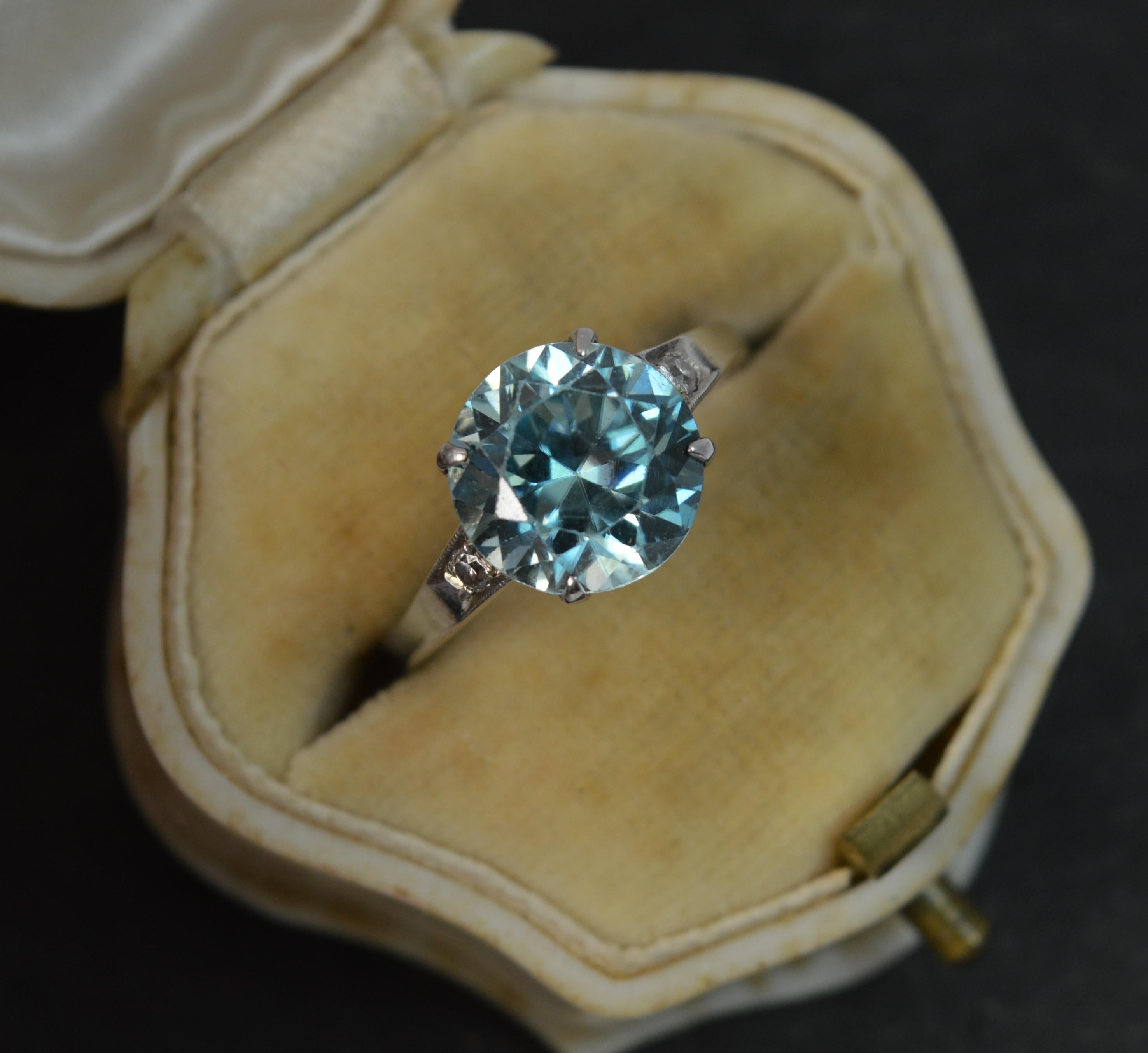 A superb and stylish ladies ring circa 1910.
SIZE ; N UK, 6 3/4 US and sizeable
Modelled in 18 carat white gold throughout.

Set with a single zircon to the centre, claw setting, 9.6mm diameter with a diamond to each side.

Protruding 6mm off the