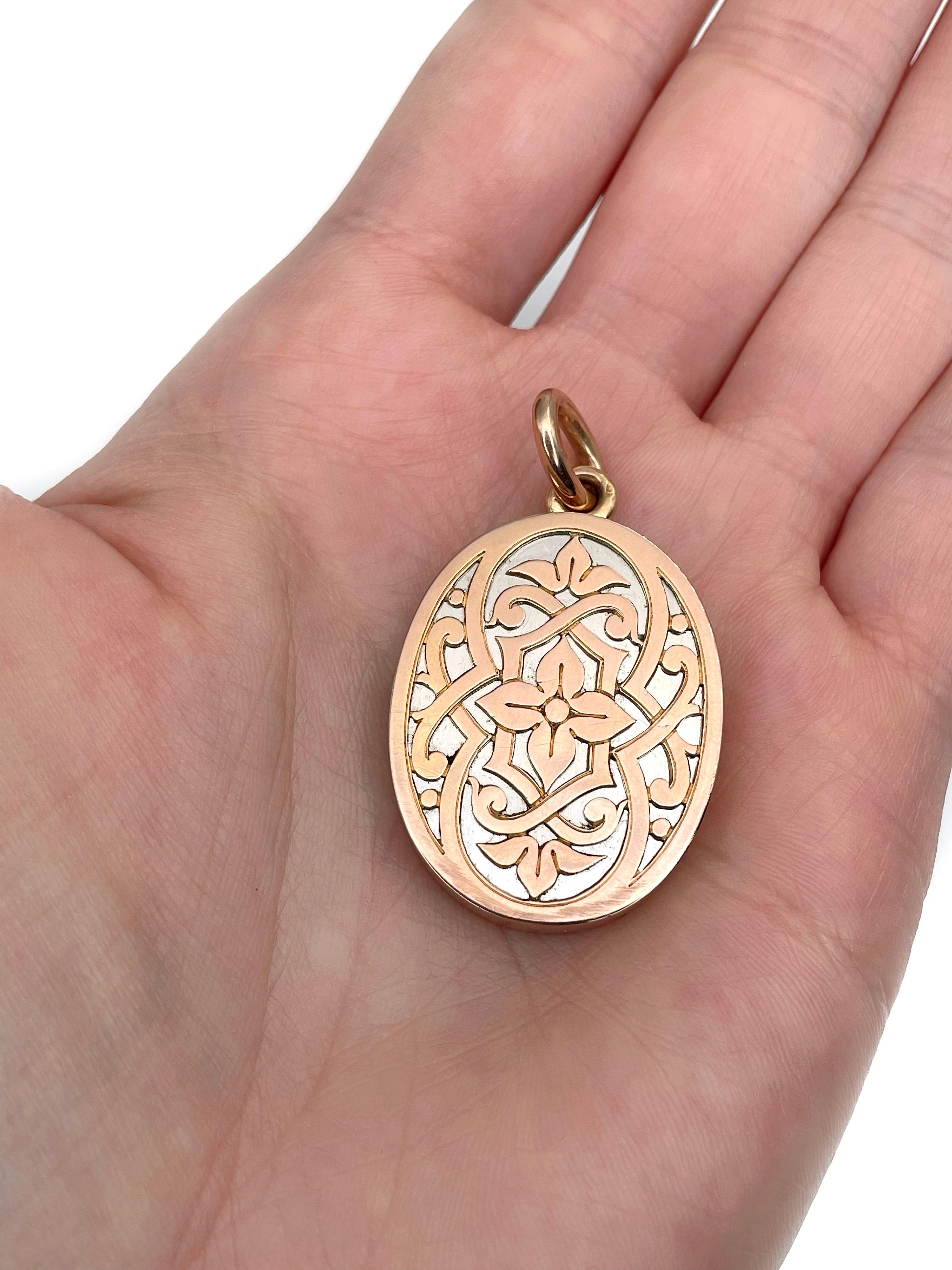 This is an Edwardian oval shape locket pendant crafted in 18K bi-colour gold. Circa 1910. 

The piece features arabesque ornaments. The back side is engraved with the initials and a crown.

There is a space for pictures inside. 

Weight: