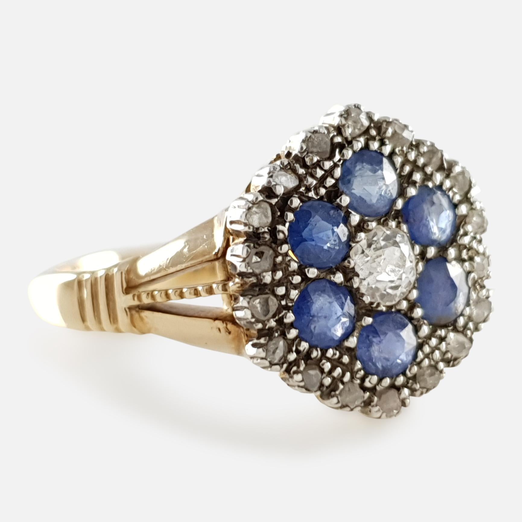 Description: - A fine antique Edwardian 18 karat gold diamond and sapphire cluster ring. The ring is set with a central diamond, surrounded by 6 sapphires, and a further 16 diamonds around the perimeter in a cluster formation, set on trifurcated