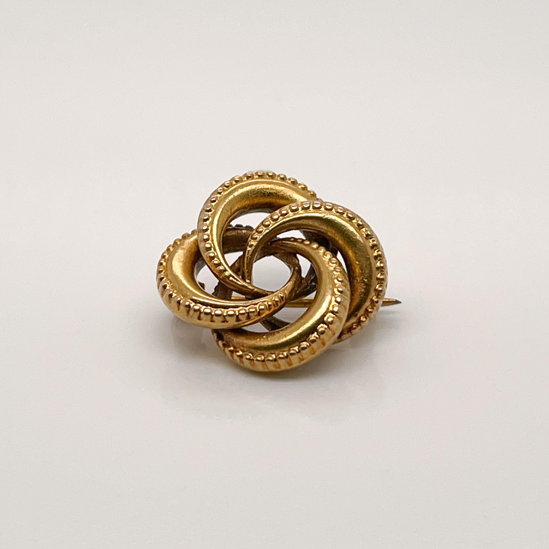 A fine Edwardian 18k gold brooch. 

In the form of a traditional 'Love Knot' with interlocking circular links.

Simply a wonderful, antique brooch! 

Date:
Late 19th or Early 20th Century

Overall Condition:
It is in overall good, as-pictured, used