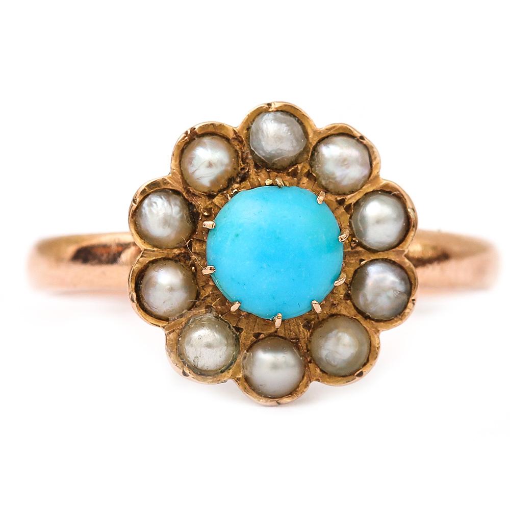 A pretty Edwardian antique turquoise and pearl cluster ring set in 18 karat rose gold. This ring would have been more than likely a love token. The turquoise denotes ‘forget me not’ taken from the tiny flower of the same hue. Ten small pearls