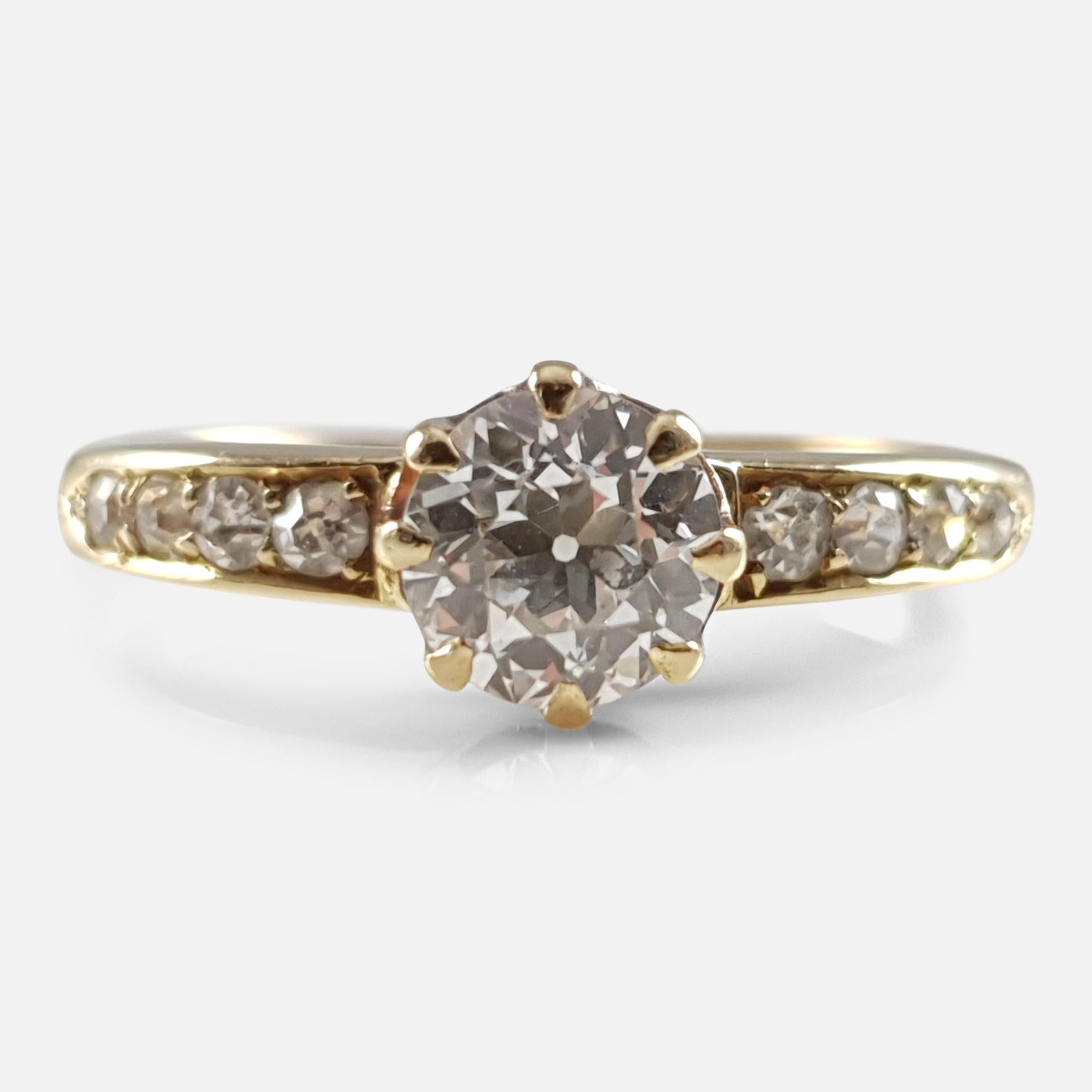 An early 20th century 18 karat yellow gold 0.90cts diamond ring. The principle old cut diamond weighs 0.75cts with the further old cut diamonds to the shoulders having a total weight of approximately 0.15cts. As was common for the period the ring is
