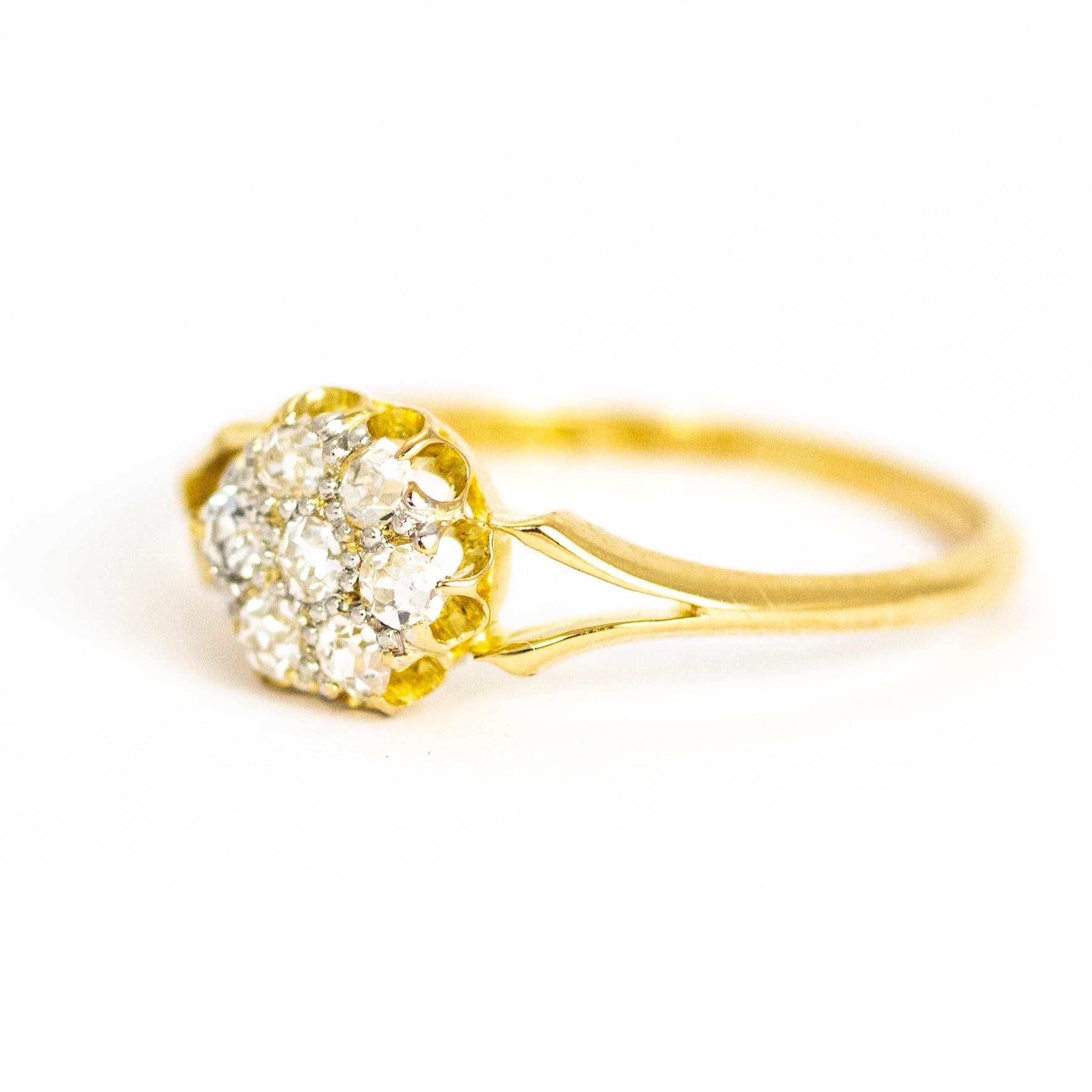 This exquisite antique Edwardian ring is set with a cluster of stunning old European cut white diamonds, between delicate open shoulders. The total diamond weight is approximately 0.35 carats. Modelled in 18 karat yellow gold.

Ring Size: UK M, US 6