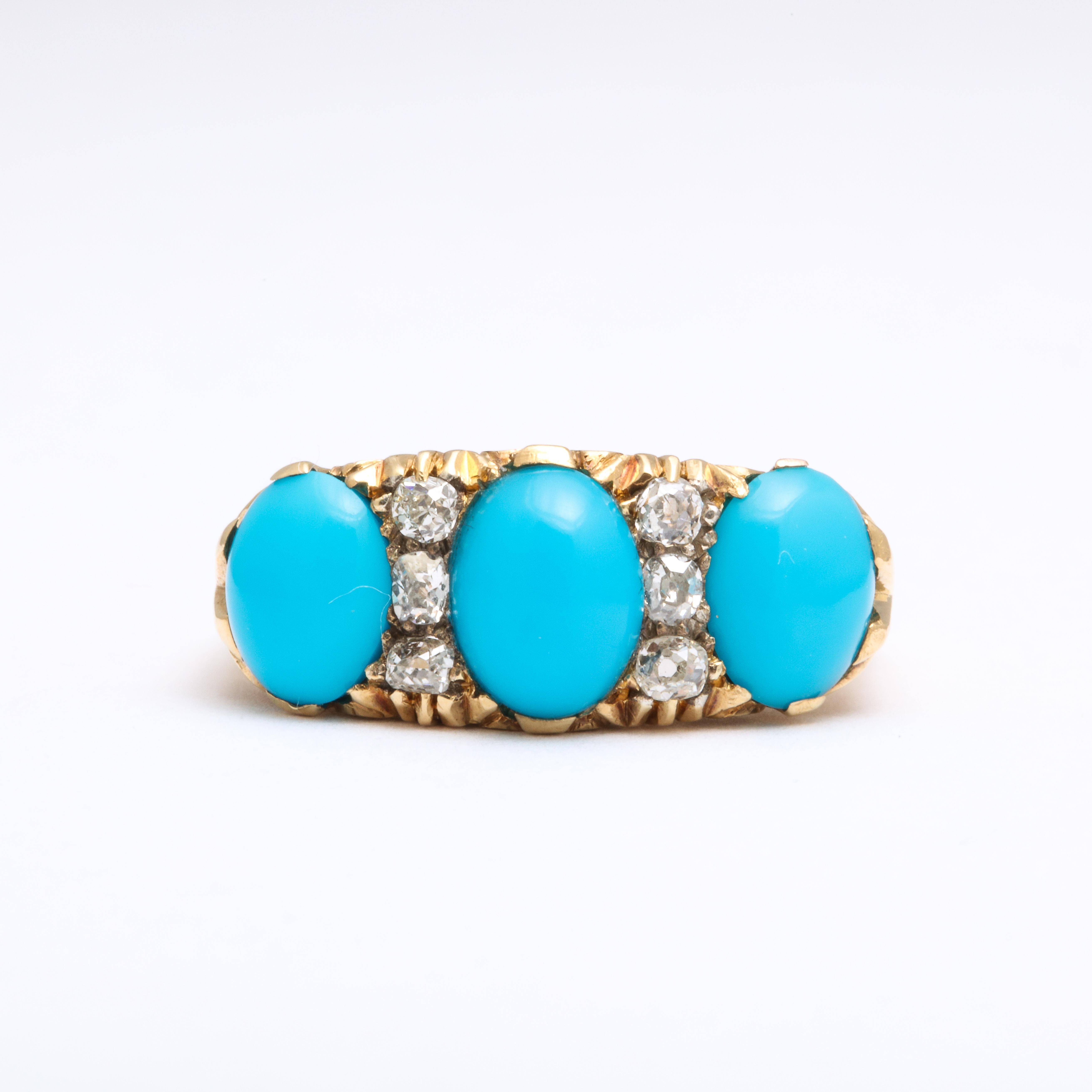 Three sky blue, oval Persian turquoise gems are separated by nine diamonds set in a stunning 18 Kt ring made c.1900 in one original piece, The shoulders are two pronged holding stones of approximately 13mm and 10mm. Added for sparkle and light, the