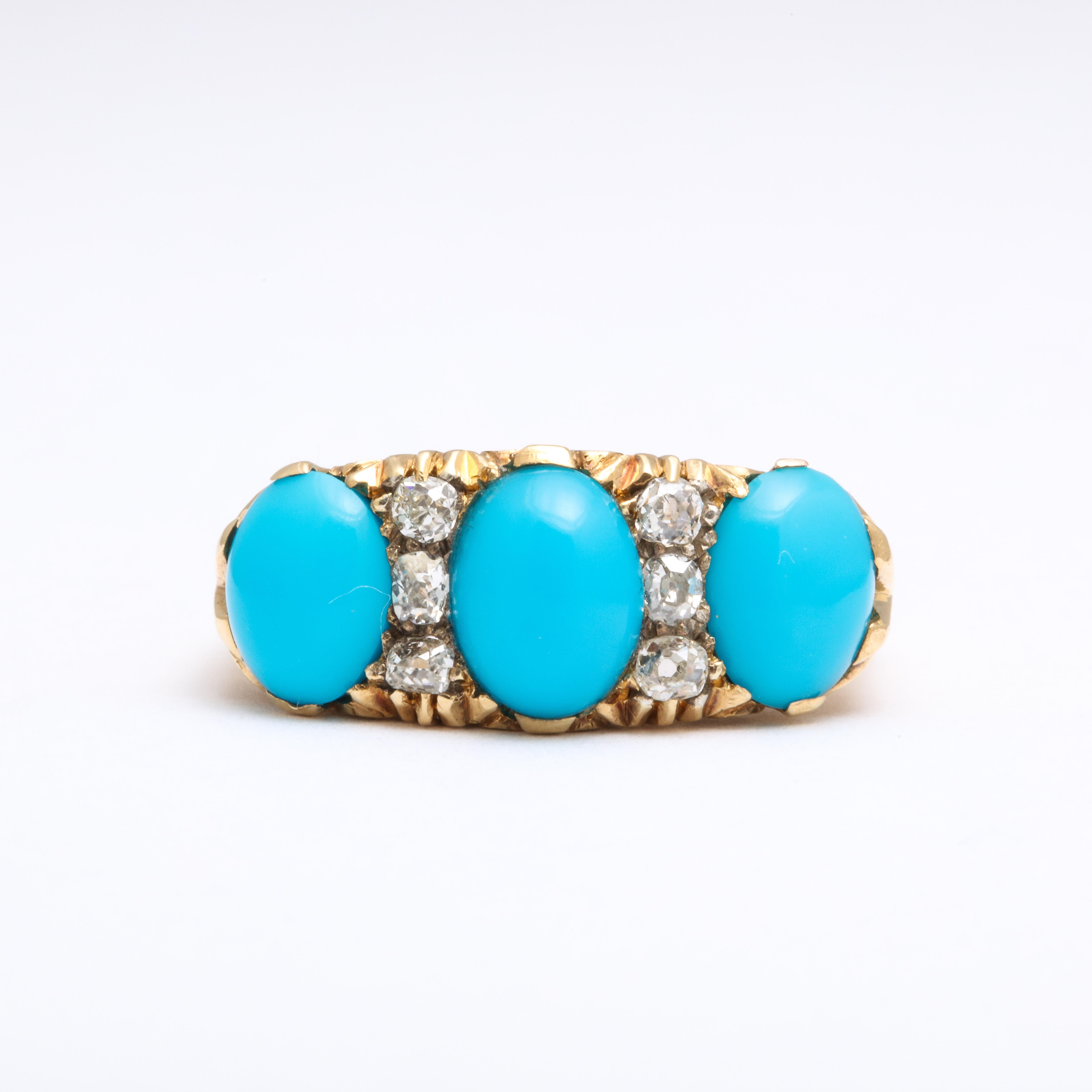 Three sky blue, oval Persian turquoise gems are separated by nine diamonds set in a stunning 18 Kt ring made c.1900 in one original piece, The shoulders are two pronged holding stones of approximately 13mm and 10mm. Added for sparkle and light, the