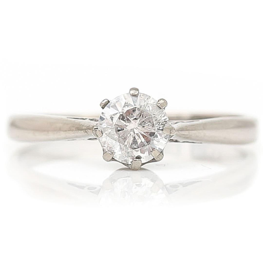 A beautiful engagement ring this antique, early 20th century 18ct and platinum ring is set with an ideally proportioned early brilliant cut diamond. The stone being I-J in colour and clarity is also good at SI. Weighing 0.50ct the stone has a good