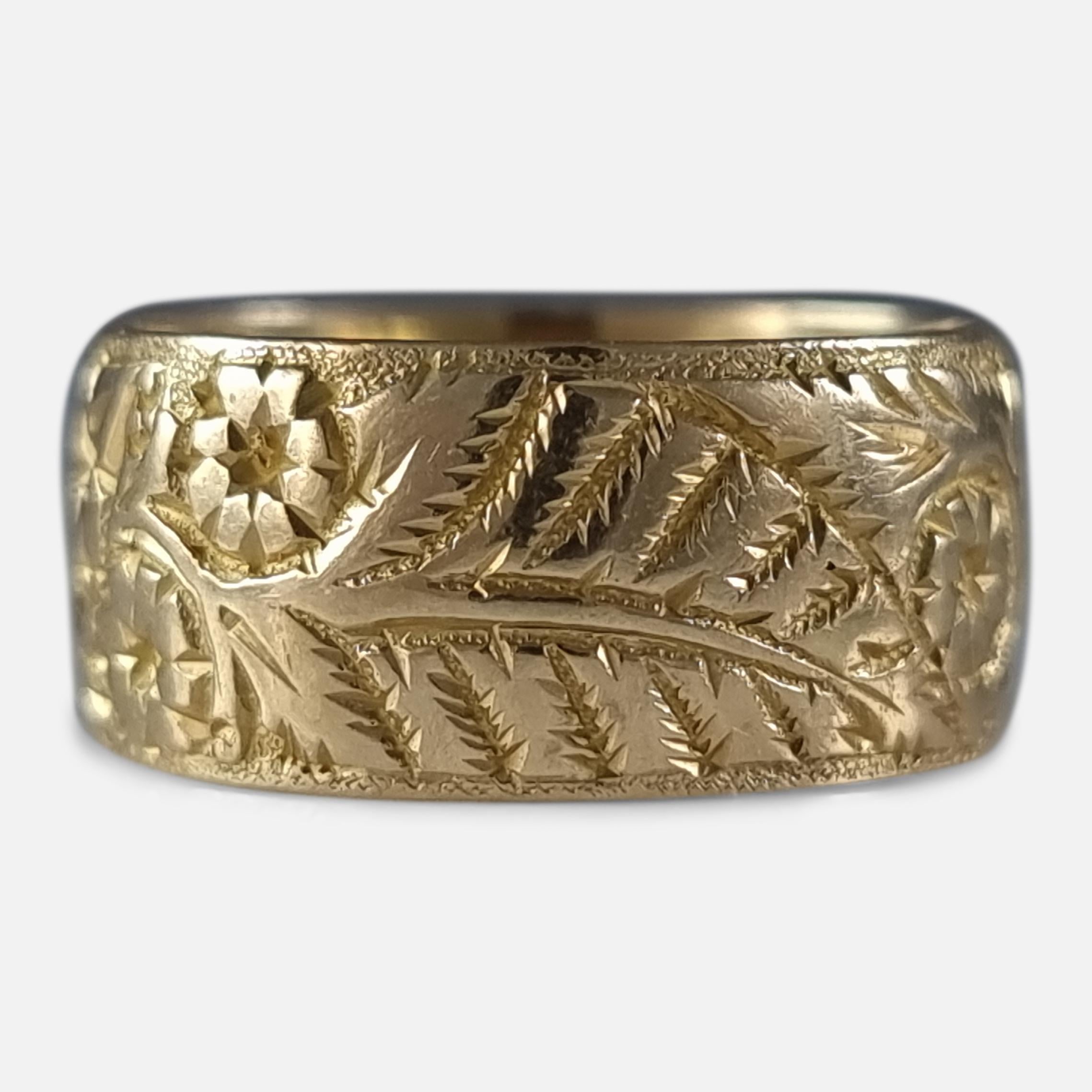 An Edwardian 18ct yellow gold engraved Keeper ring. The ring is engraved with an embossed foliate decoration.

The ring is hallmarked with Birmingham marks, '18' for 18 carat gold, and date letter 'g' to denote 1906.

Assay: - .750 Gold