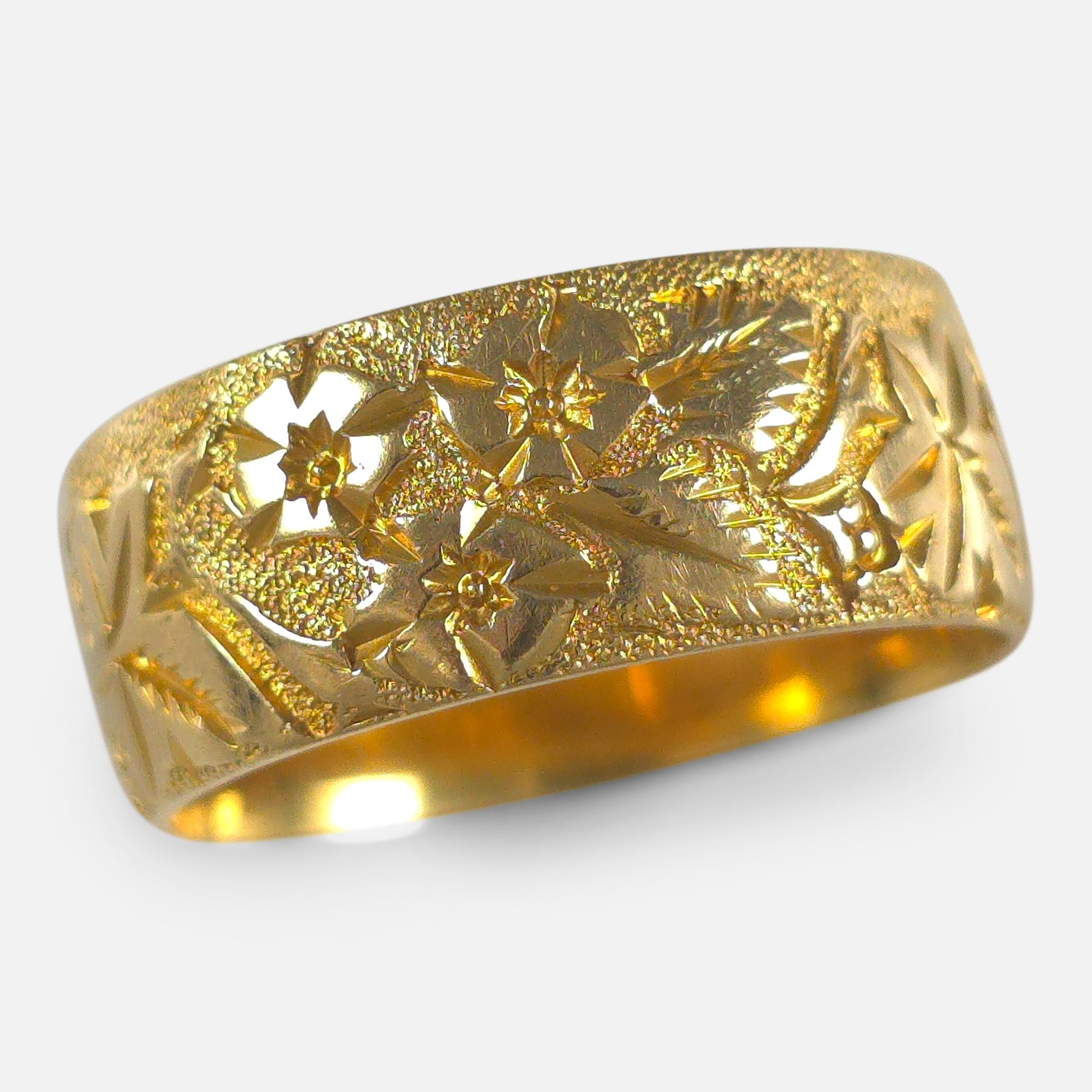 Edwardian 18ct yellow gold Keeper ring, engraved with a foliate decoration.

• Assay: .750 Gold (18ct), Chester Assay marks.
• Period: Early 20th Century.
• Date: Circa 1905 (Date stamp is rubbed).
• Maker: Marked 'JE'.
• Measurement: UK ring size M