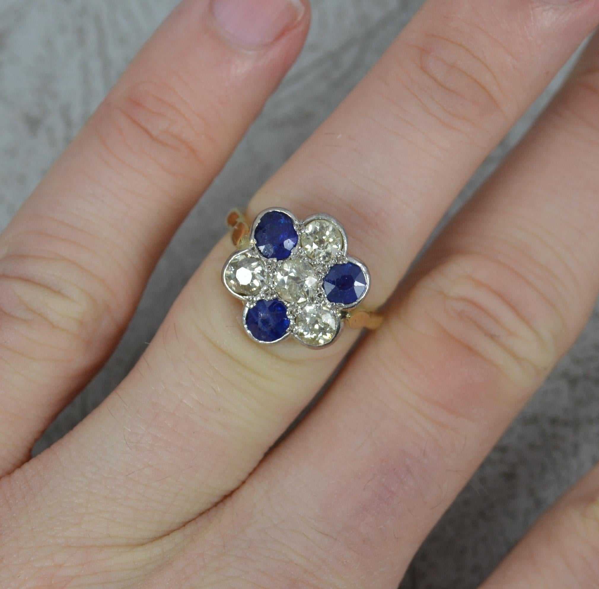 A beautiful late Victorian or Edwardian period cluster ring.
Solid 18 carat yellow gold shank with platinum head setting.
Three natural blue sapphires and four natural old cut diamonds. Total diamond carat weight of 1.00 carats.
13.8mm x 14.3mm