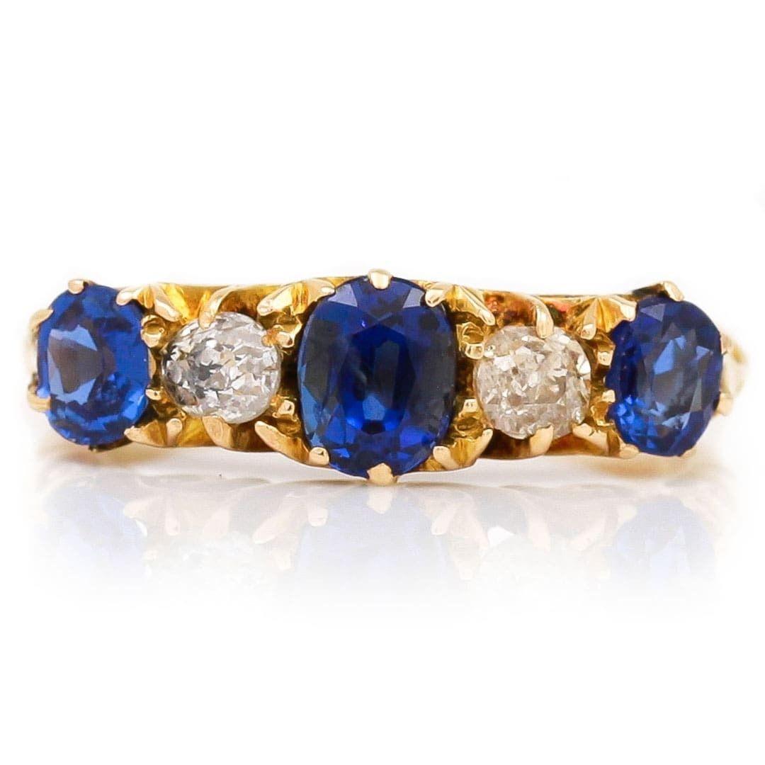 A beautiful Edwardian deep, Kashmir blue sapphire and old cut diamond five stone ring, in a carved claw setting. Made in 18ct yellow gold this ring was made in 1909, the rich blue sapphires we estimate at 0.75ct in total with a 0.35ct centre stone.