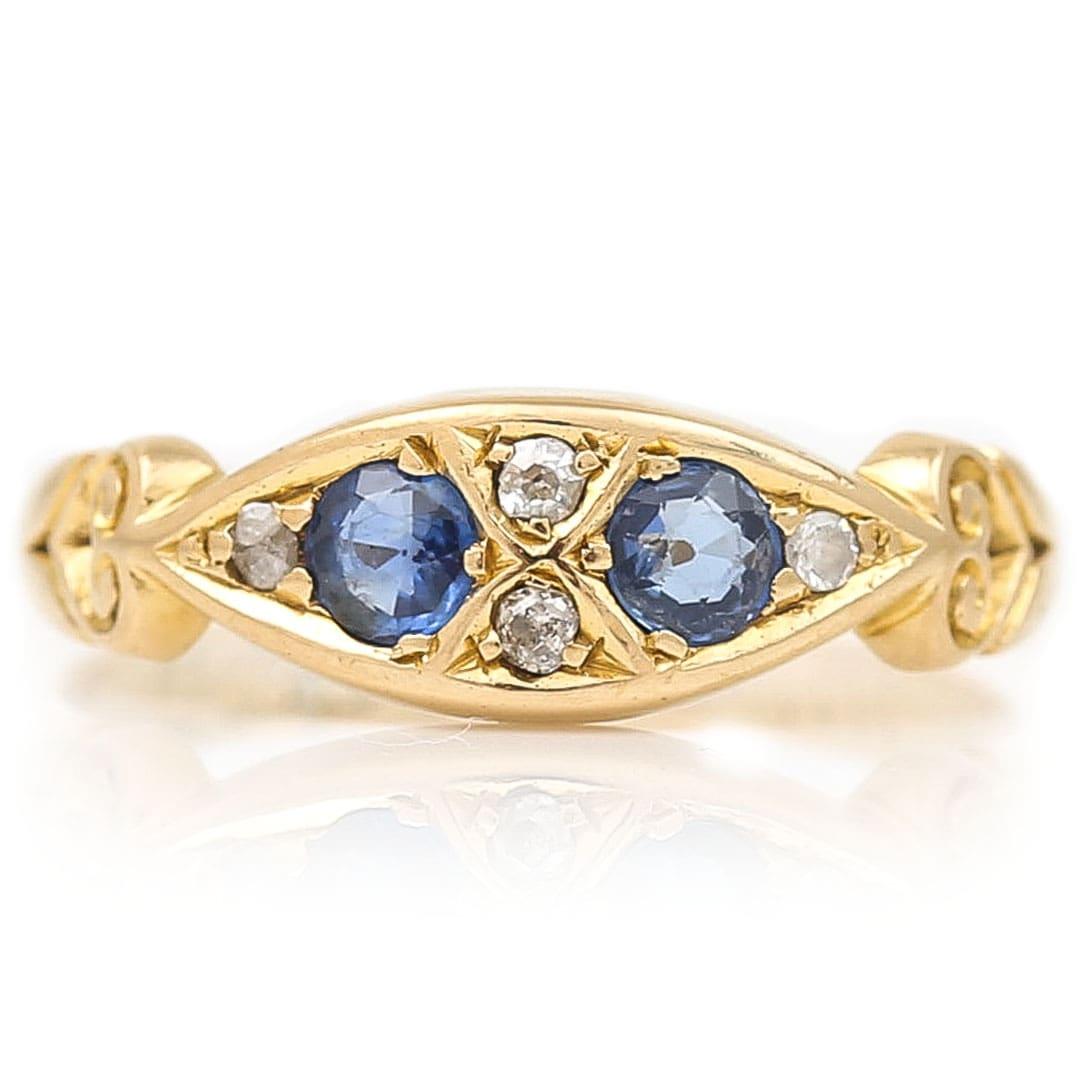 A delightful 18ct yellow gold, blue sapphire and diamond gypsy ring that was hallmarked in 1907 in Chester, England. It’s a very pretty example, with the twin royal blue sapphires of a pleasing colour and clarity. The claw set stones are all old cut