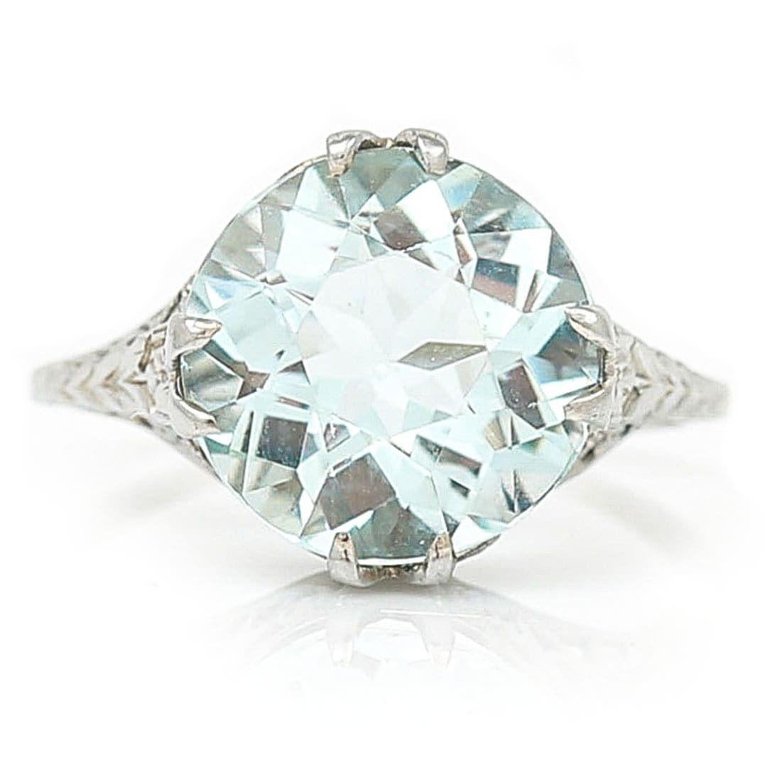 A fine and impressive Edwardian 4ct round cut aquamarine solitaire ring set in 18ct white gold hand crafted circa 1910. The central set round, faceted aquamarine is a delightfully inviting pale blue and weighs approx. 4cts. The setting and shank are