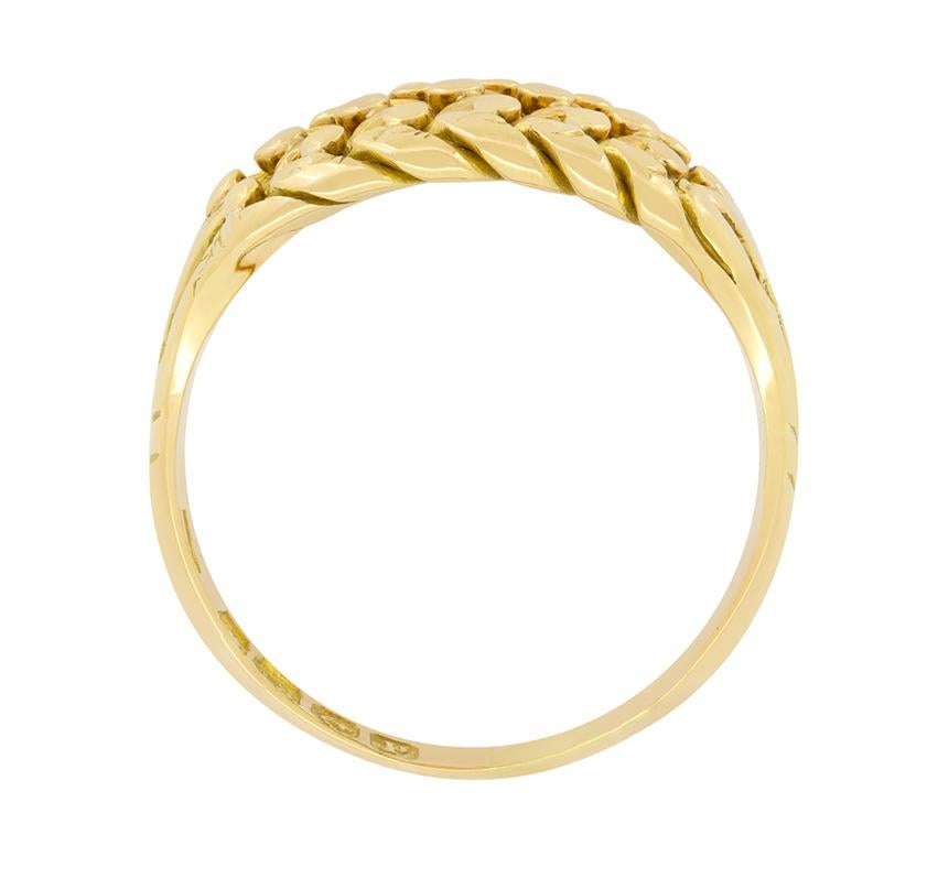Crafted circa 1914, this gents Keeper ring has been crafted in 18 carat yellow gold. An intricate woven pattern, 11.3mm in width tapers down into a simple band making this impressive ring very wearable. The giving of a keeper ring is said to have