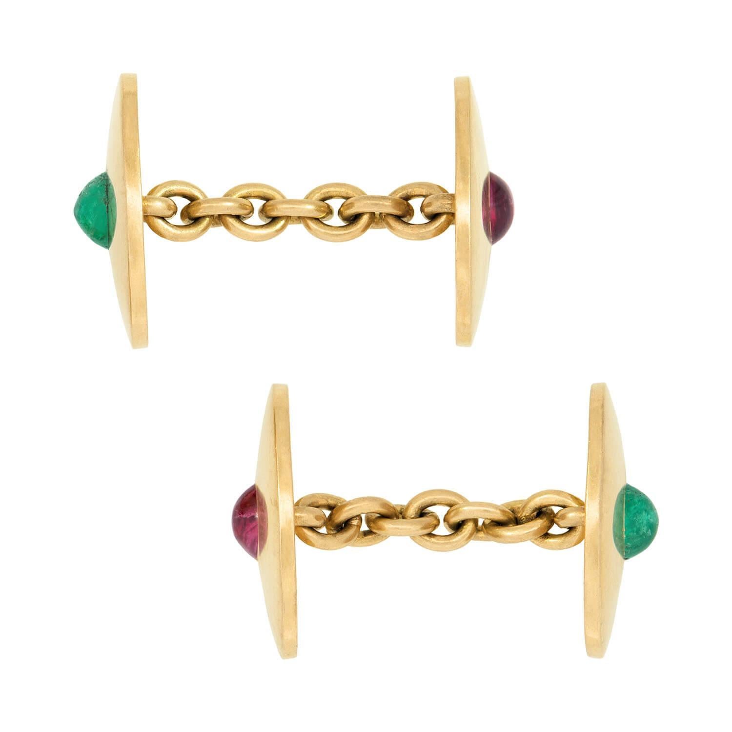 A beautiful pair of gemstone cufflinks from the Edwardian (ca1910) era! Crafted in vibrant 18k yellow gold, these double-sided cufflinks are bursting with detail. Each oval cufflink face has a smooth and simple surface and features a bezel set