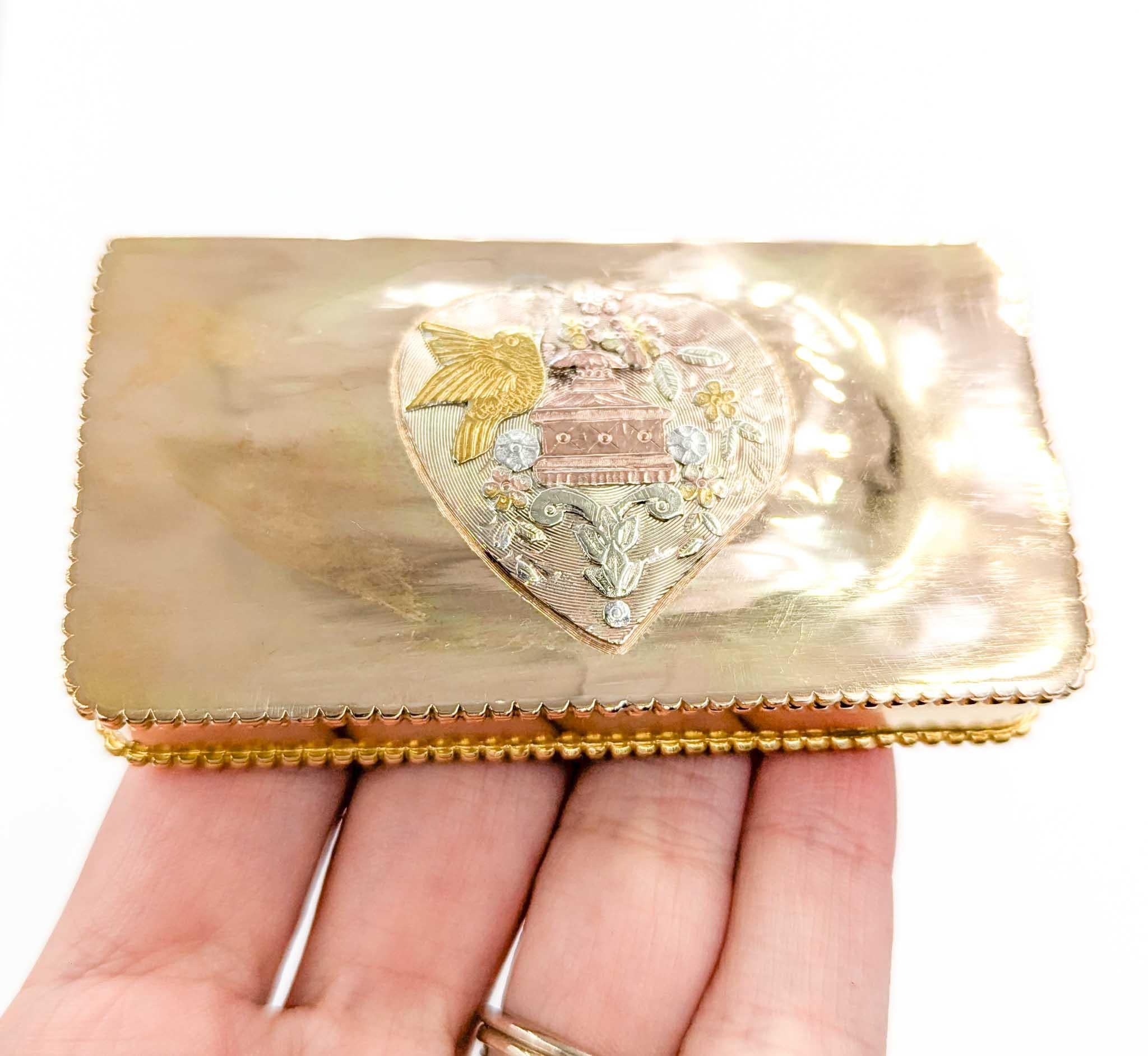 Exquisite Edwardian 18k Gold Snuff Box/Pill Box with Heart Motif and Birds

This extremely rare Edwardian-era snuff box, doubling as a matchbox or modern-day pill box, is a masterwork of craftsmanship from the early 20th century, dating back 100 to
