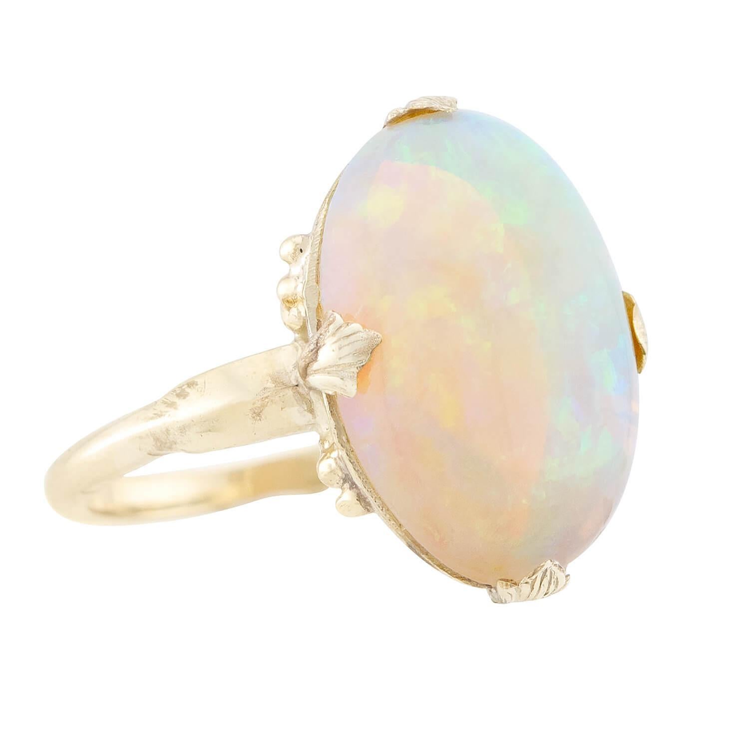 This opal ring from the Edwardian (ca1910s) era makes quite a stylish accessory! Hand-crafted in 18k yellow gold, the ring features an exquisite opal stone that is held within a four-prong setting. The prongs resemble small leaves, which adds a