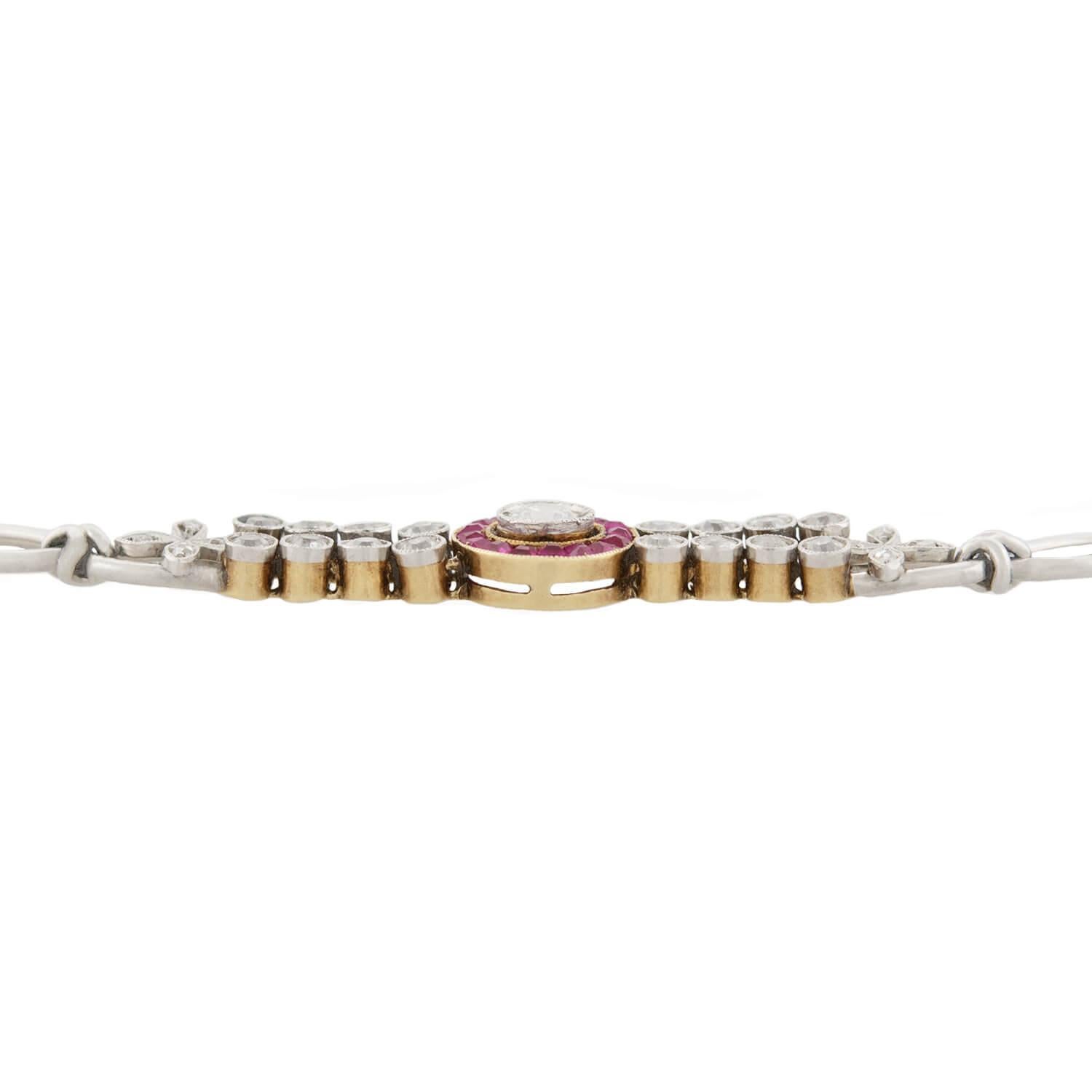 An absolutely stunning diamond and ruby encrusted bracelet from the Edwardian (ca1910) era! This gorgeous piece is made of platinum and 18k yellow gold and features a striking ruby and diamond centerpiece. Resting in the center of the bracelet is an