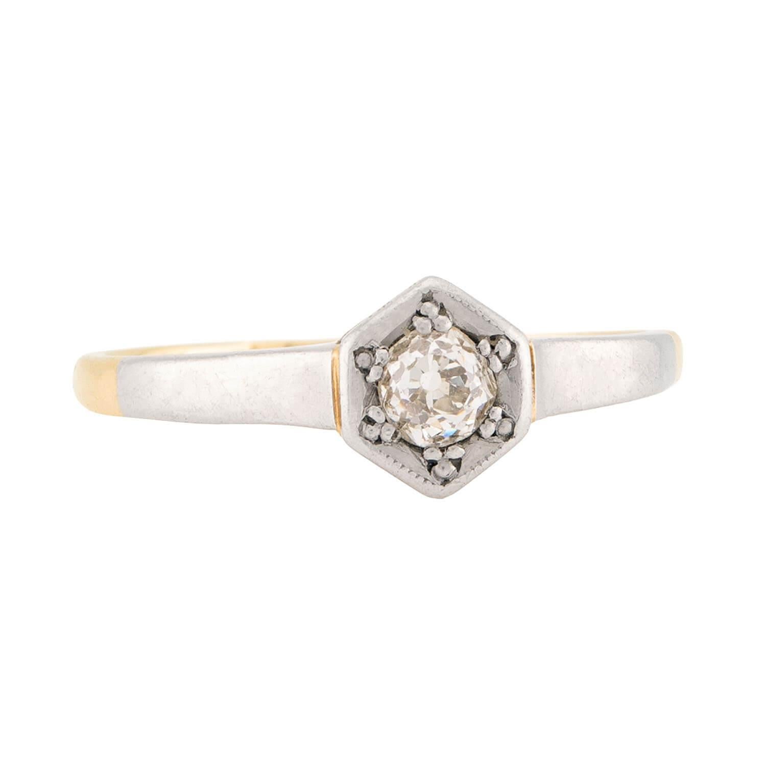 A beautiful diamond engagement ring from the Edwardian (ca1910s) era! Crafted in 18k yellow gold and platinum, this ring features a solitaire old mine cut diamond. The diamond has an approximate carat weight of .20ct and displays K/L color and VS2