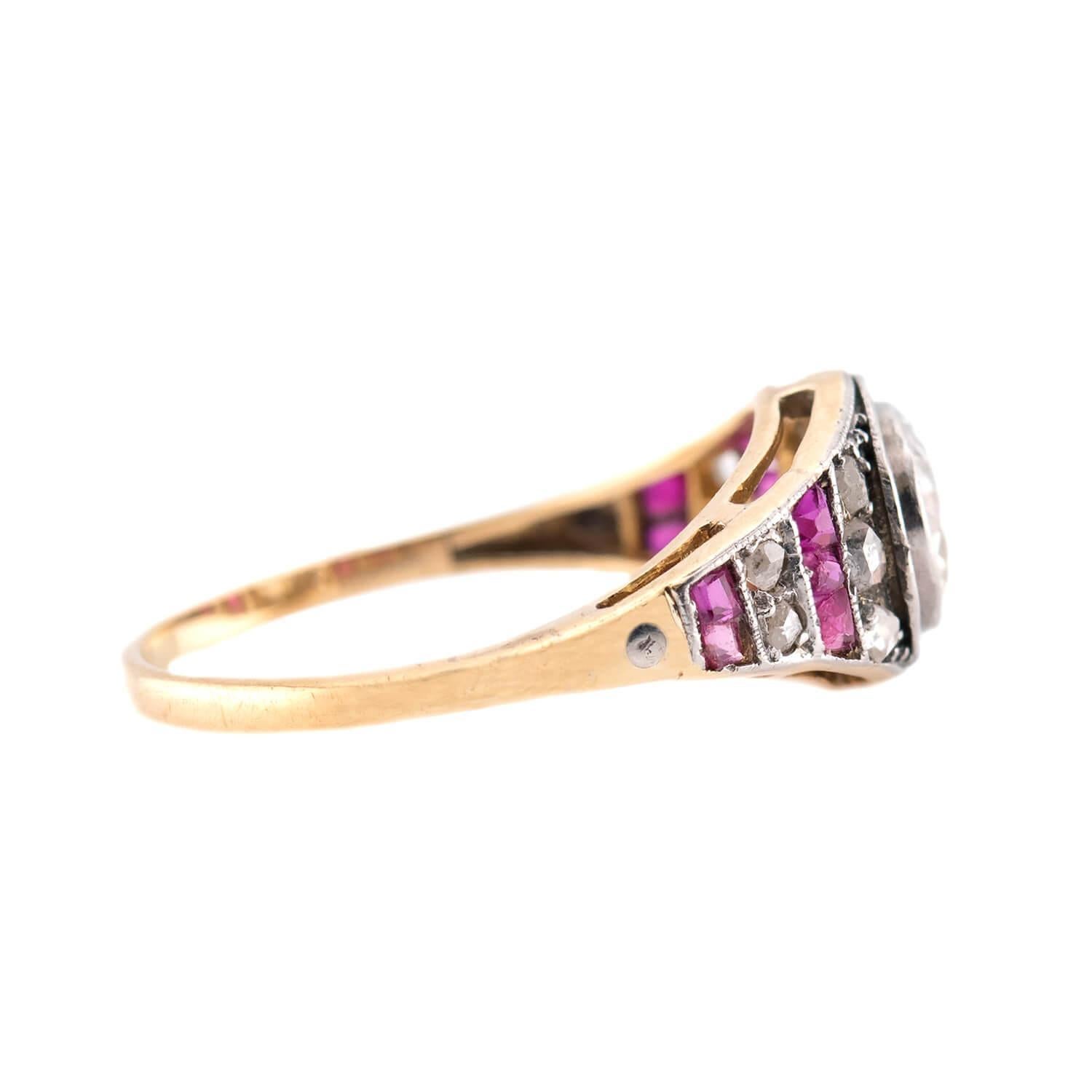 A fantastic engagement ring from the Edwardian (ca1910s) era! Crafted in 18k yellow gold and platinum, this ring features a central .90ct bezel-set old European cut diamond. The diamond displays J color and SI2 clarity. The diamond is surrounded by