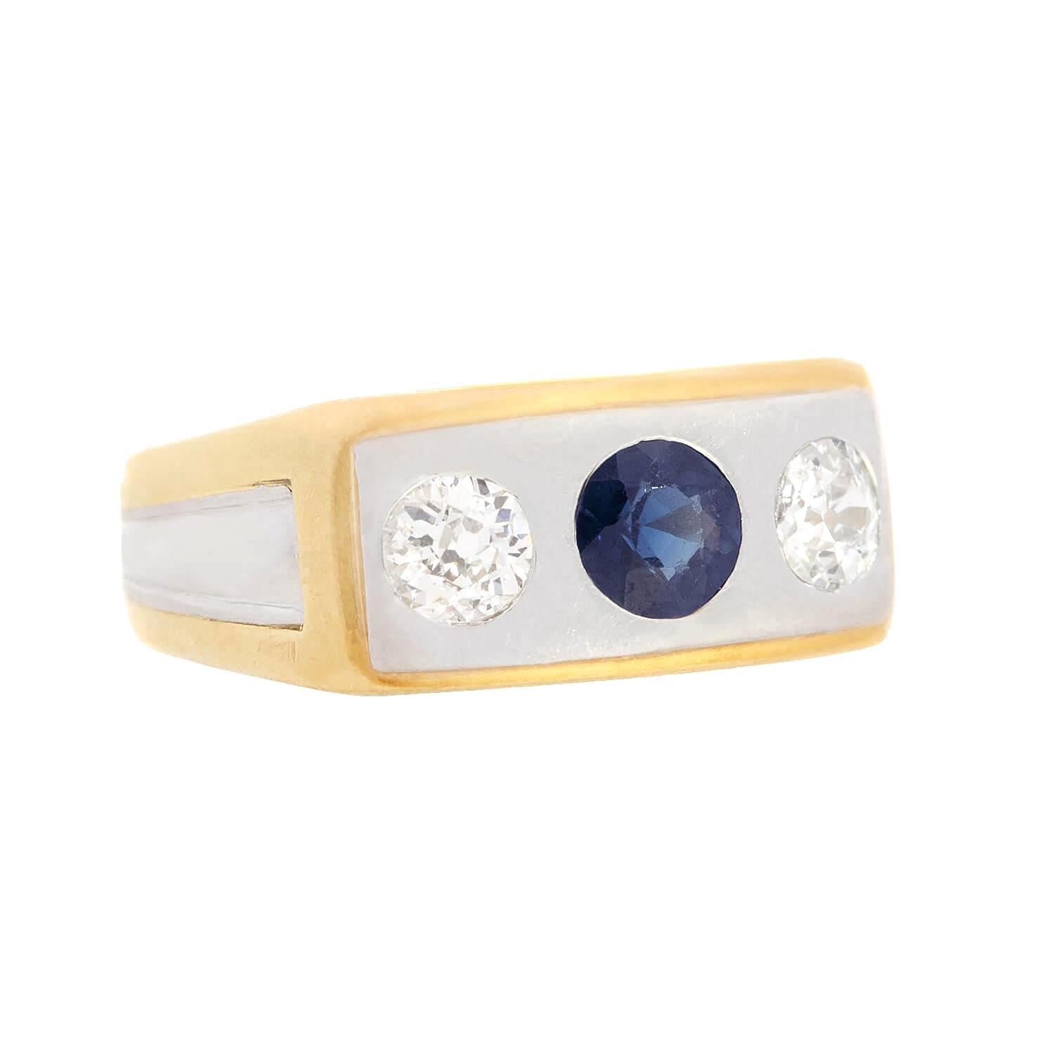 A gorgeous diamond flush mount ring from the Edwardian (ca1910s) era! Crafted in 18k yellow gold and platinum, this rings features two diamonds and a stunning sapphire held within flush bezel settings. The mine cut diamonds weigh an approximate